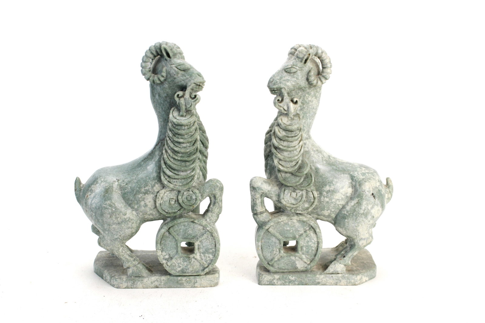 Pair of Carved Stone Ram Sculptures: Pair of carved stone ram sculptures with stylized details, each approx. 8 3/4 in. (H) ? 5 1/2 in. (L) ? 2 1/2 in. (W). Good condition with natural stone variations, surface wear, minor chips, and smal