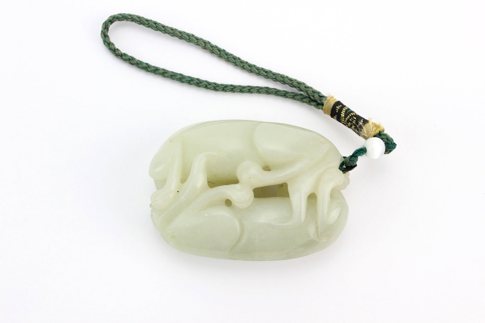 Chinese Jade Pendant w Mythical Beasts: Chinese carved pale celadon jade pendant featuring intertwined mythical beasts with pierced openwork design and cord attachment. Measures approximately 2 1/4 in. (L) x 1 3/4 in. (W) x 1 in. (H).