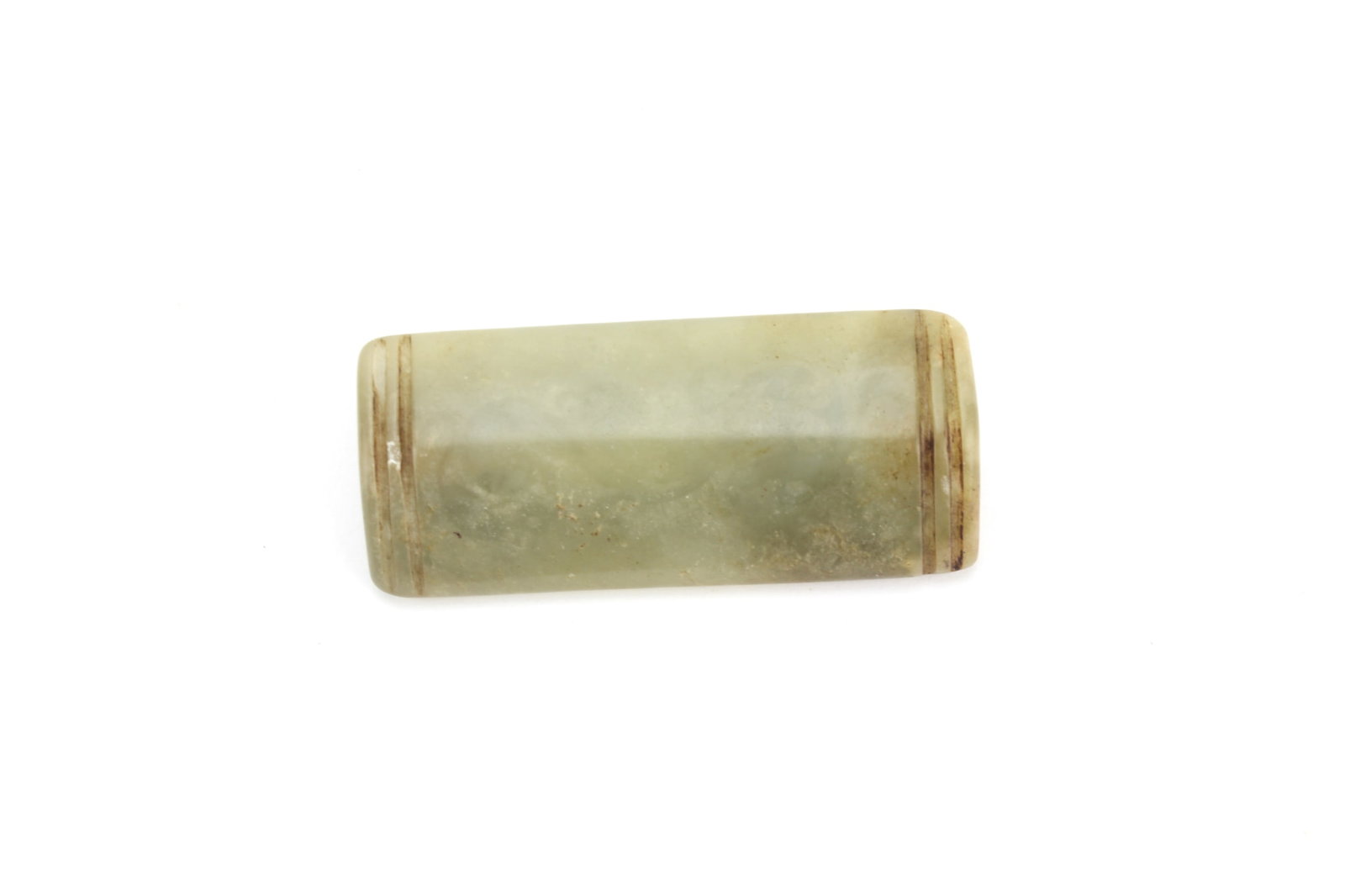 Chinese Jade Tube Form Pendant: Carved Chinese jade pendant of elongated tube form with incised band decoration at each end. Measures approximately 2 1/2 in. (L). Shows natural inclusions, surface wear, minor discoloration, and