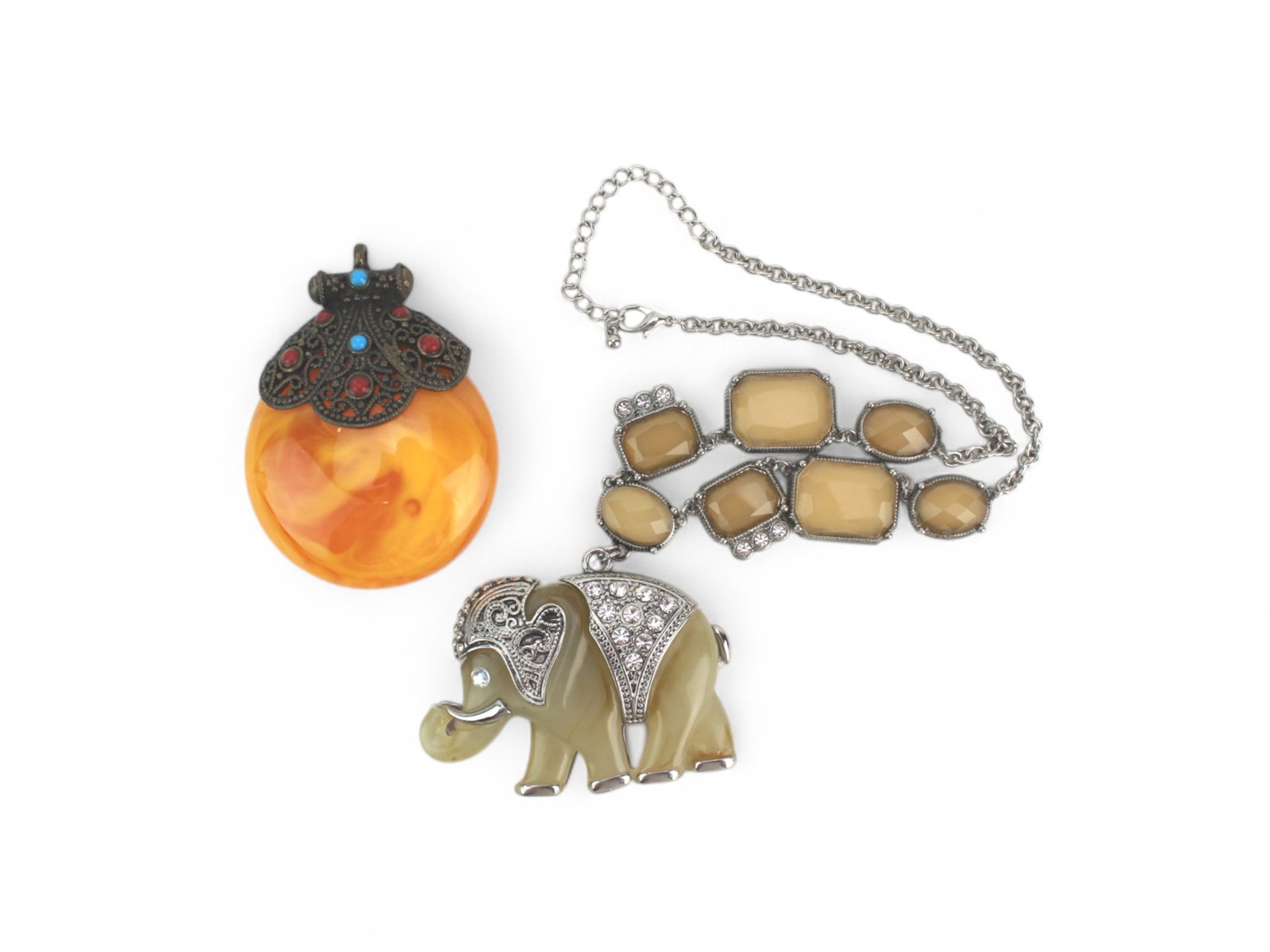 Two Asian Style Pendant and Necklace Set: Lot of Two Asian-Style Jewelry Pieces ? Includes a large Tibetan-style amber-colored resin pendant with ornate metal filigree and faux turquoise and coral, and a necklace with rhinestone-embellished e