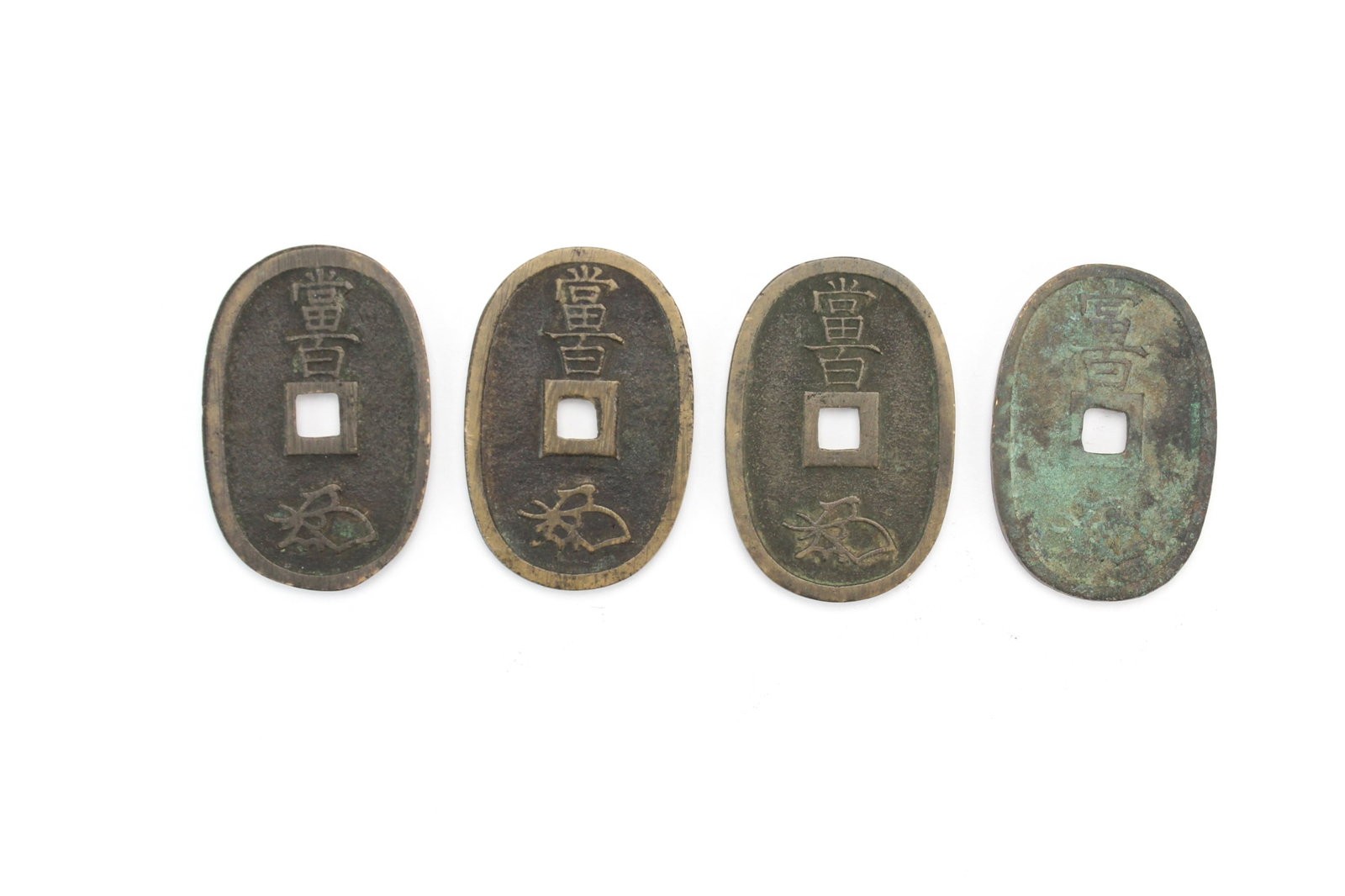 Four Japanese Bronze Tenpo Tsuho Coins: Four Japanese Bronze Coins, Tenpo Tsuho, Edo period, with a face value of 100 mon. Dimensions in 49.1 mm (L) by 32.7 mm (W).