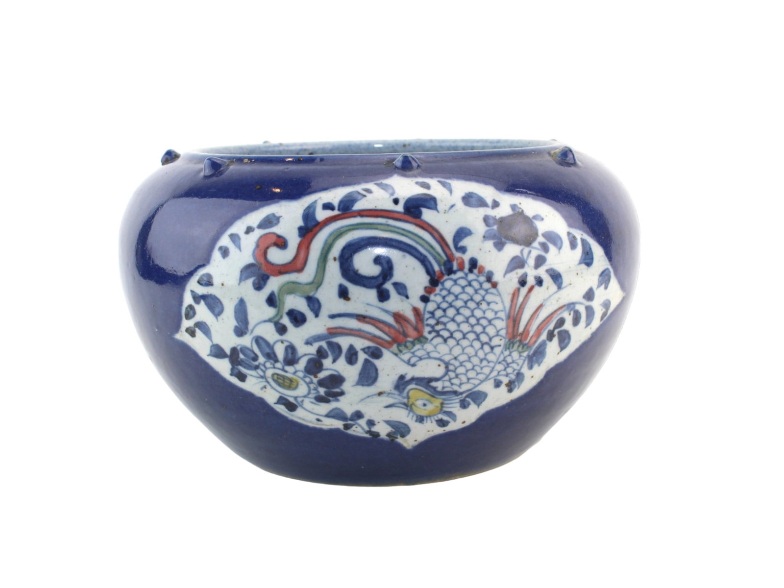 Chinese Blue Glazed Bowl with Phoenix Motifs: Chinese blue-glazed porcelain bowl with phoenix and floral panels, applied rim nodules, and light surface wear. Approx. 11 in. D X 6 in. H.