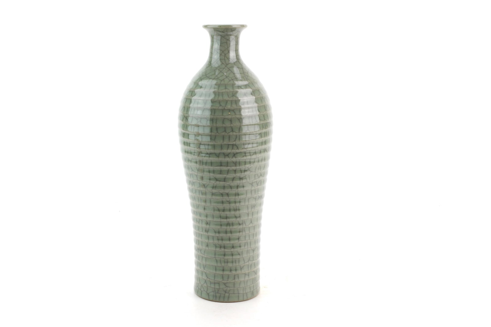 Chinese Celadon Crackle Glazed Ribbed Vase: Chinese celadon porcelain vase of elongated bottle form, decorated with horizontal ribs beneath a pale green crackle glaze. Character mark to the underside. Measures 10 1/4 in. (H) X 3 1/2 in. (D).