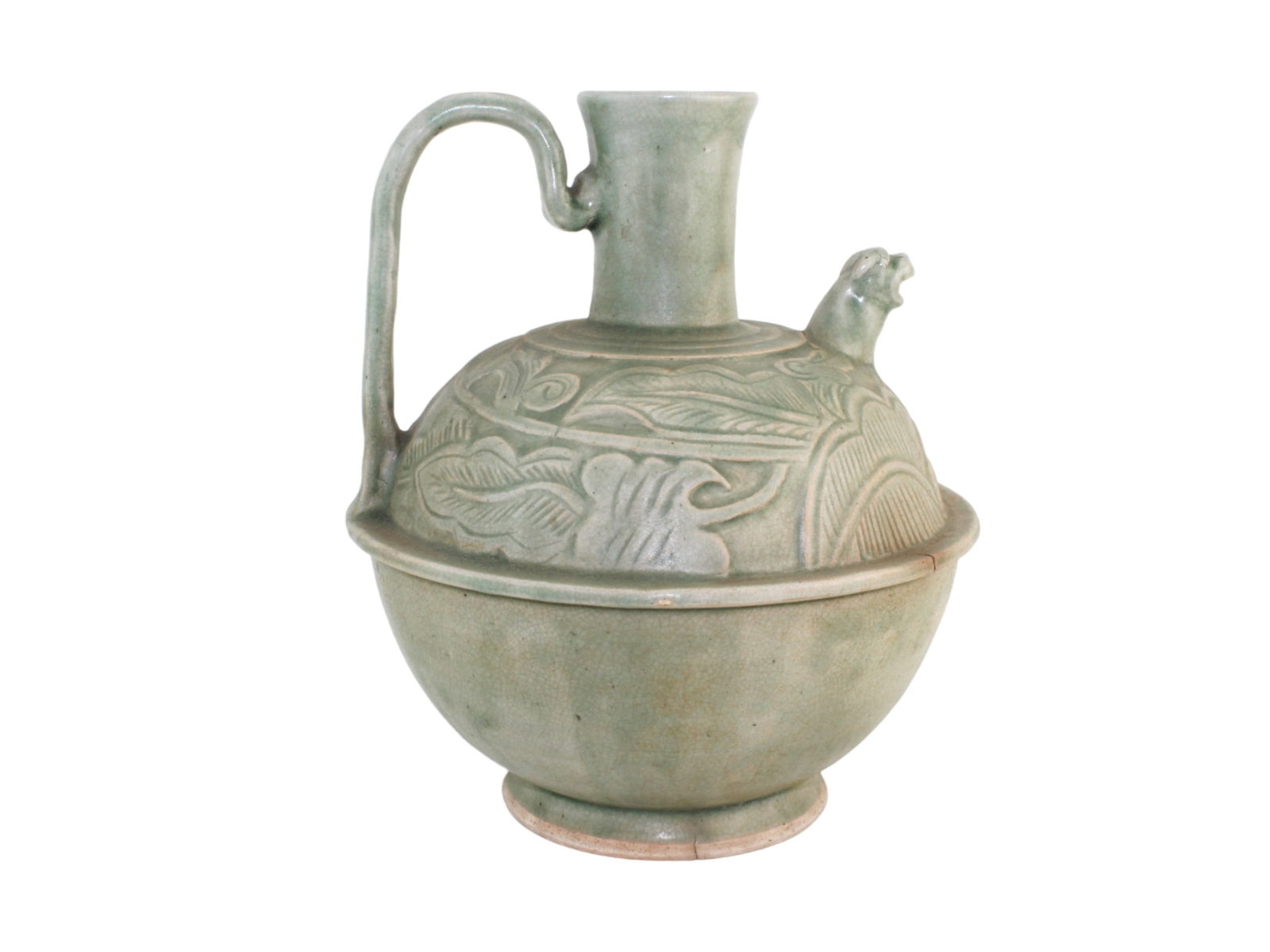 Chinese Celadon Ewer with Carved Floral Motif: Chinese celadon ewer with carved floral motifs and crackled glaze. Approx. 12 in. H X 10 in. D. Visible firing flaws and crack near handle.