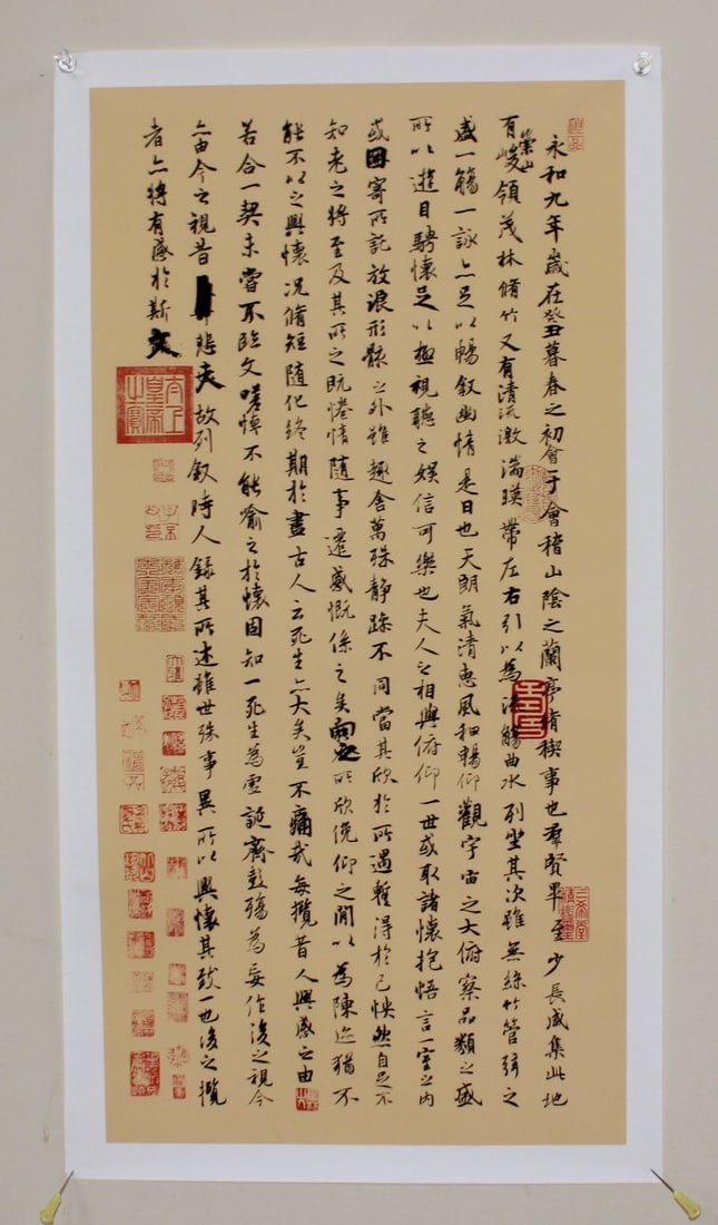 Chinese calligraphy Scroll Print: Elegant Chinese calligraphy print featuring classical script in black ink on a tan background, adorned with numerous red seals. Approx. 11 in. (W) X 22 in. (H). The print is in good condition with no 
