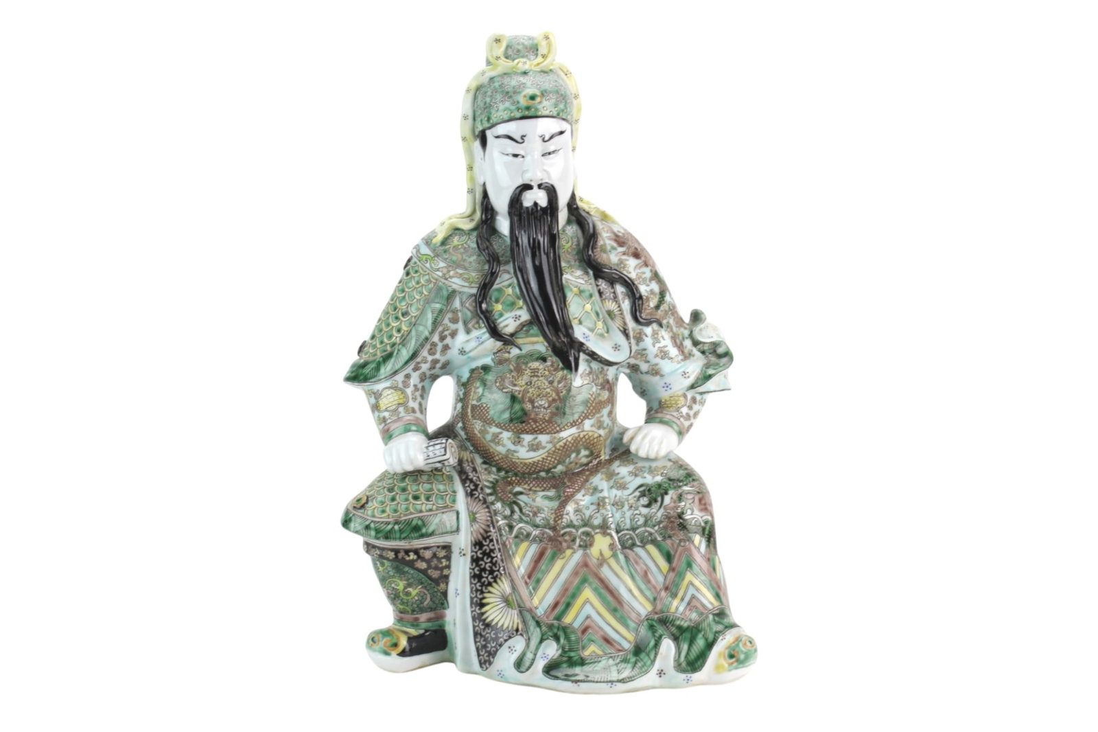 Chinese Famille Verta Porcelain Warrior Figure: Chinese polychrome Famille Verta porcelain figure depicting Guangong seated in an imposing pose, wearing elaborate armor and robes richly decorated with dragons, waves, geometric patterns, and famille