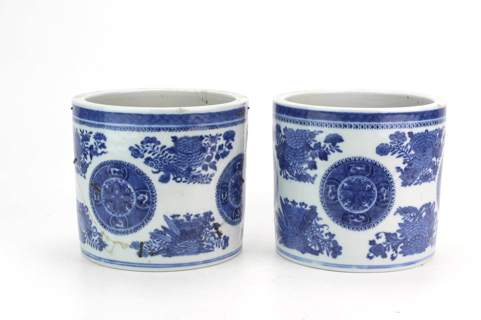 Pair Chinese Fitzhugh Blue & White Brush Pots: Pair of Chinese Fitzhugh blue and white porcelain brush pots of cylindrical form, decorated with floral sprays and circular medallions. Each measures approximately 6 in. (H) X 6 1/2 in. (D).