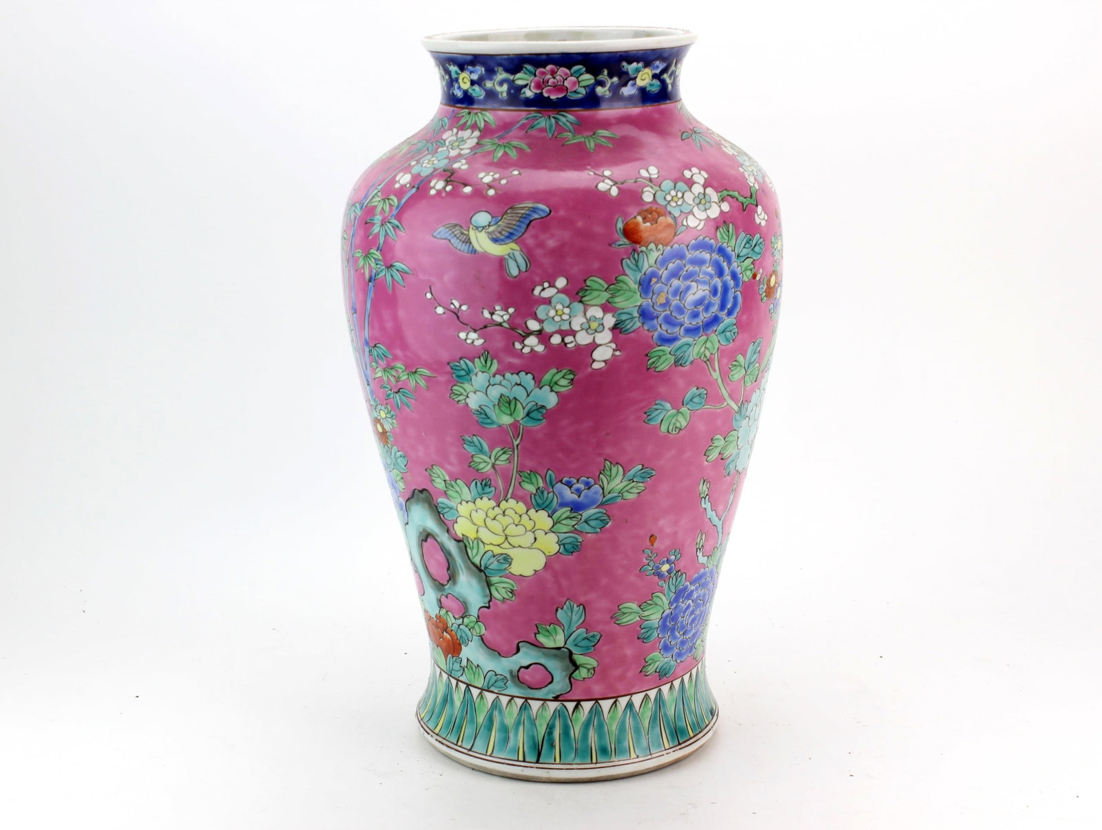 Chinese Famille Rose Pink Ground Vase: Chinese famille rose porcelain vase with a vivid pink ground, decorated with colorful flowering branches, bamboo, rockwork, and birds, with floral and lappet borders. Measures 14 in. (H) X 8 1/2 in. (