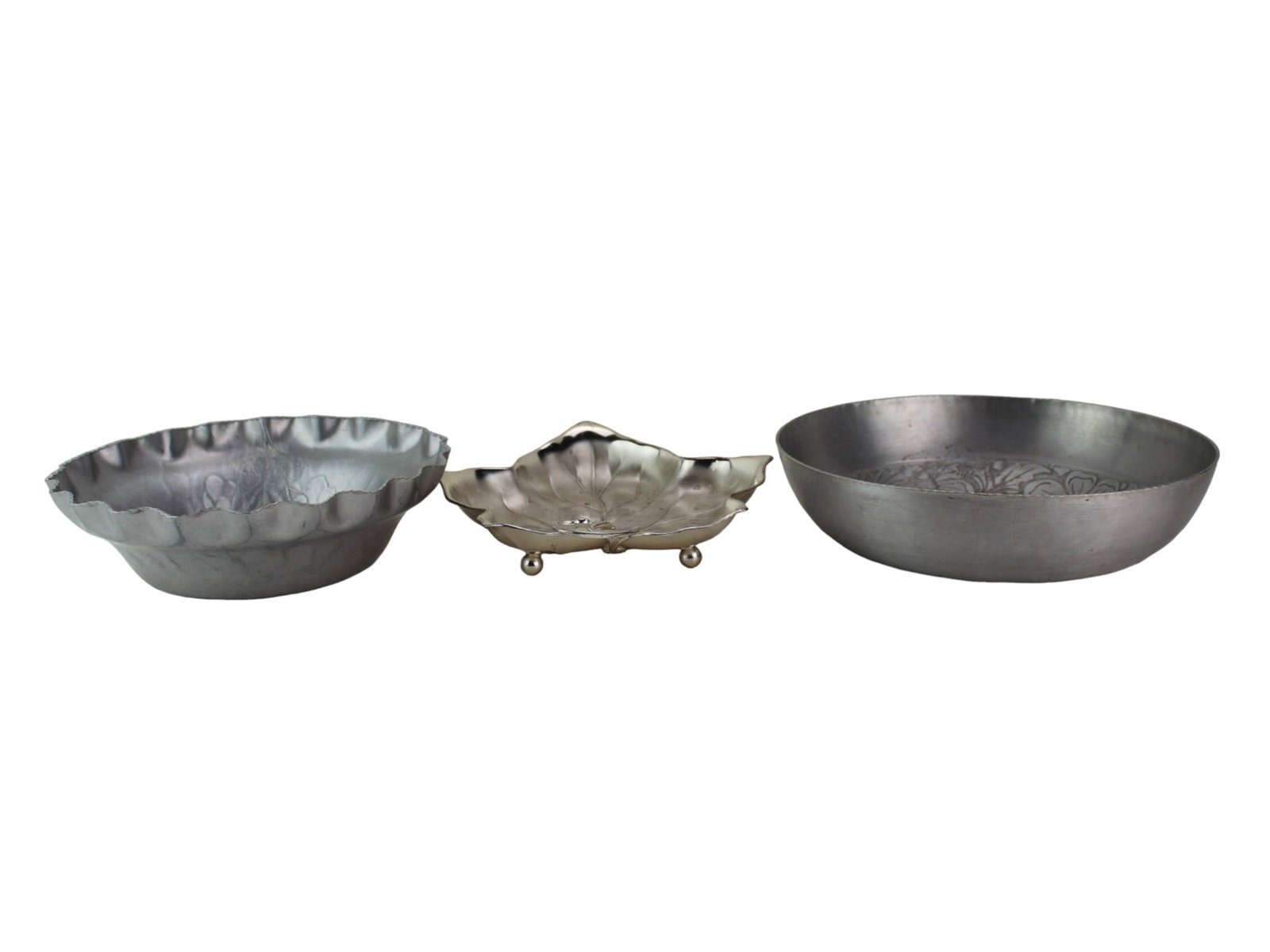Three Metal Table Serving Bowls: Includes one hand forged bowl in 8 1/2 in. (D) X 2 1/2 in. (H); WMF-Ikora silverplate Leaf shape plate in 9 1/4 X 8 X 1 3/4 in.; and one Everlast 5046 Forged Aluminum bowl in 9 3/4 in. (D) X 2 1/4 in.