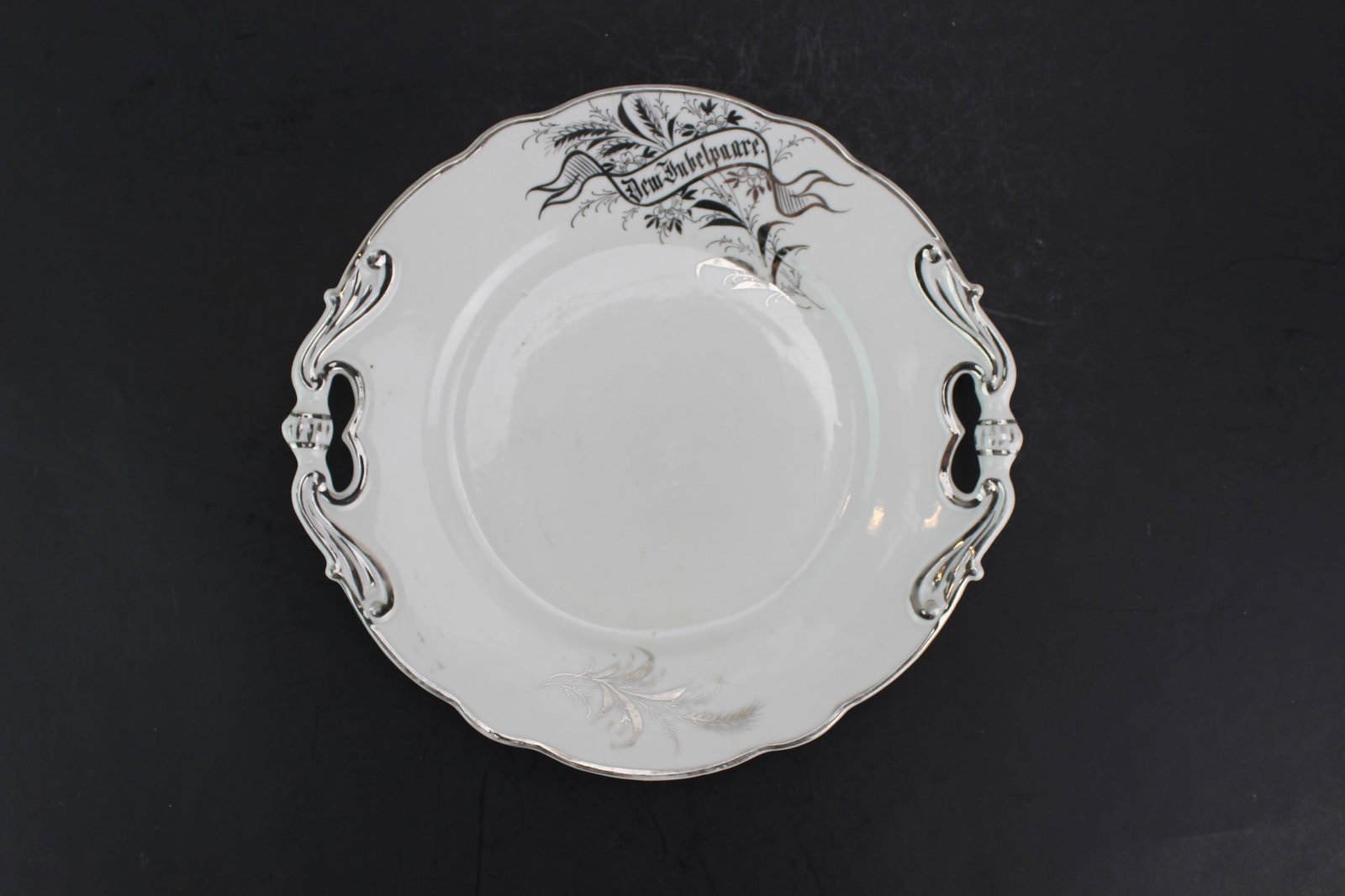 One White Porcelain Plate With Silver Edge: Dimensions: 10 1/2 in. X 10 in..