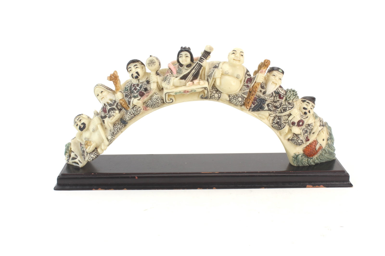 Immortals Resin Arch Figurine: Decorative resin figurine featuring Chinese immortal figures arranged in an arch form on a fitted wood base. Measures approximately 9 1/2 in. (L) X 4 1/2 in. (H) X 2 in. (W). Shows light surface