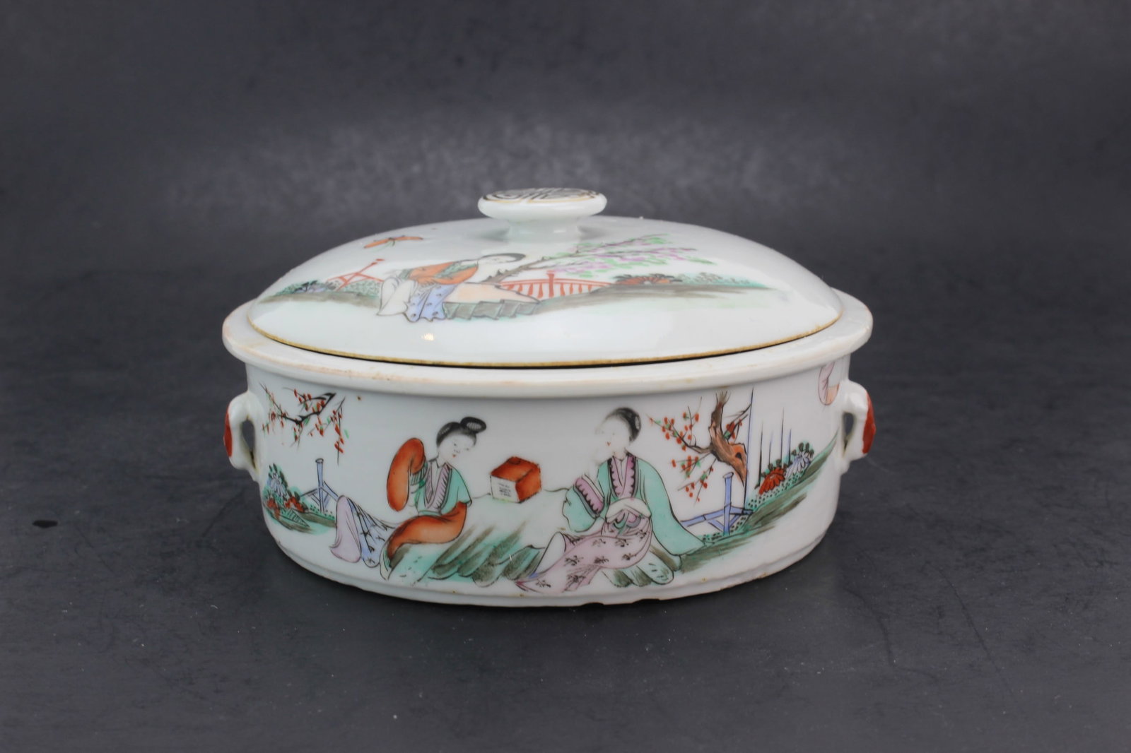 Chinese Famille Rose Lidded Bowl: Chinese famille rose porcelain lidded bowl decorated with figural scenes and calligraphy. Measures approximately 5 3/4 in. (D) x 3 in. (H). Overall good condition with light wear and firing