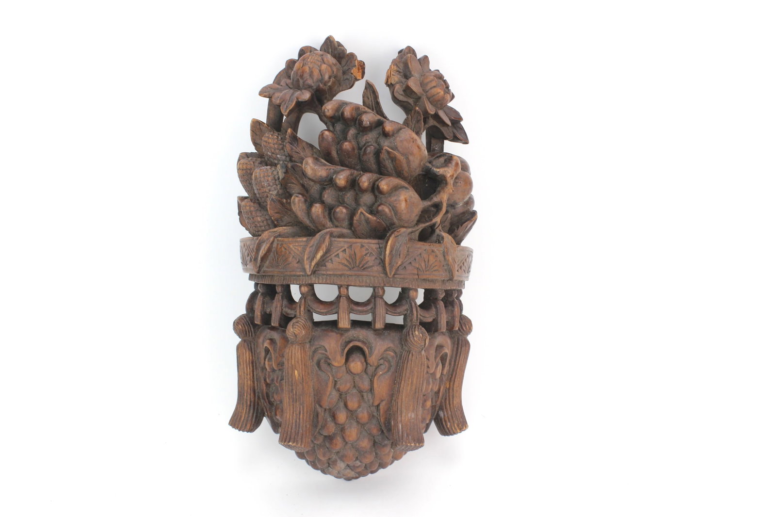 Chinese Carved Wood Fruit Decoration: Chinese carved wood hanging basket form decorated with fruit, leaves, and floral motifs. Measures 10 in. (L) X 6 in. (W) X 3 in. (H). Age-related wear, surface scratches, with losses on the top, and s