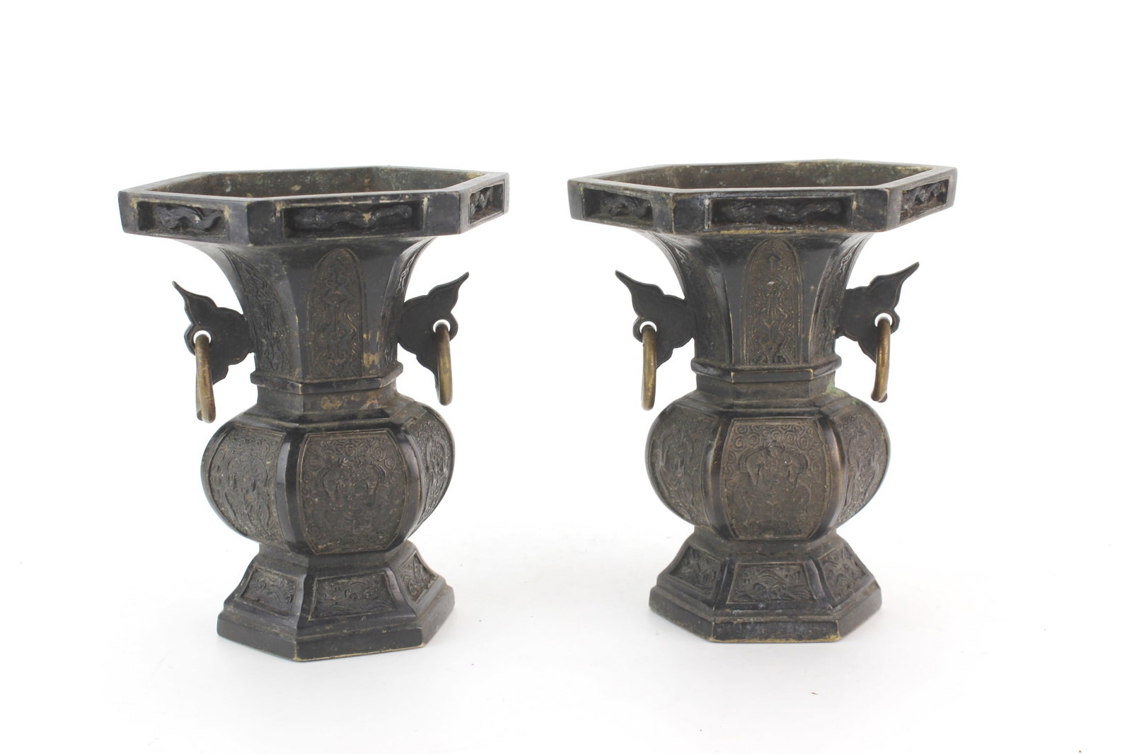 Pair Chinese Hexagonal Bronze Vases: Pair of Chinese hexagonal bronze vases with ring handles, decorated with dragon, phoenixes and waves. Each measures 4 3/4 in. (H) X 4 in. (D). Surface wear, oxidation, casting imperfections, residue,