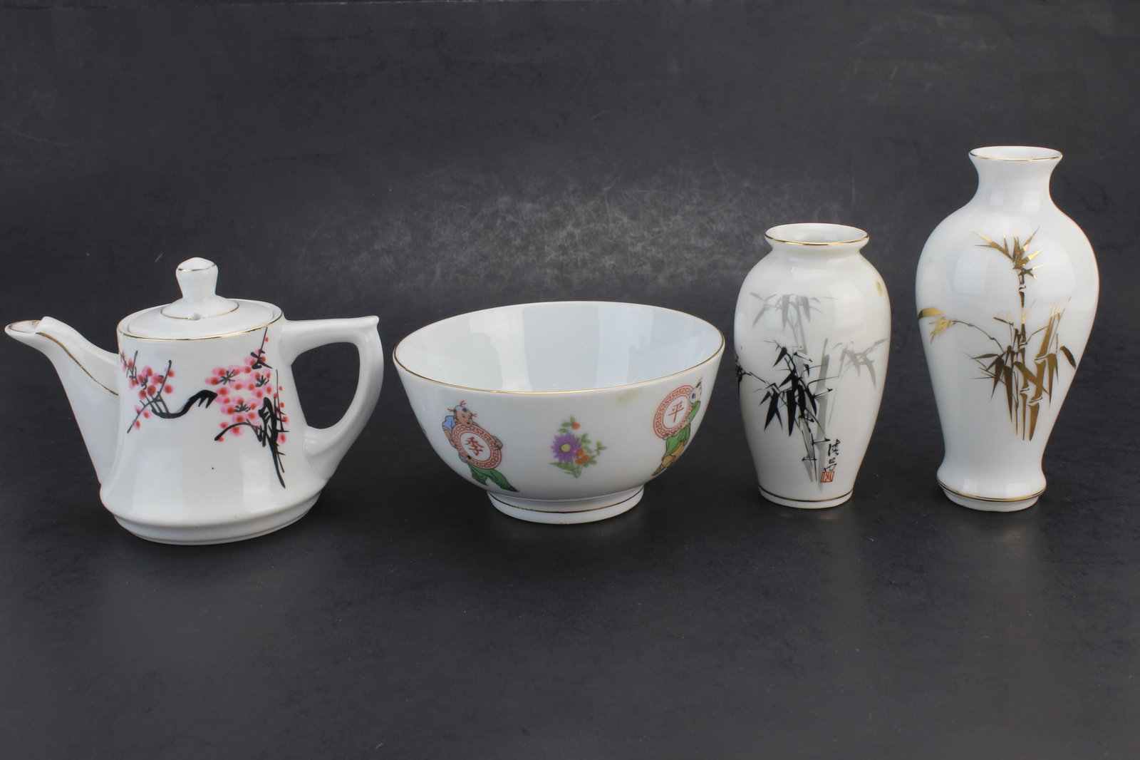 4 Chinese Export Porcelain Items: Group of 4 Chinese export porcelain items including two bamboo-decorated vases, one floral teapot, and one bowl with figural decoration. Sizes: vases 3 3/4 in. and 5 in. tall; teapot 5 in. (L) x 3 3/4