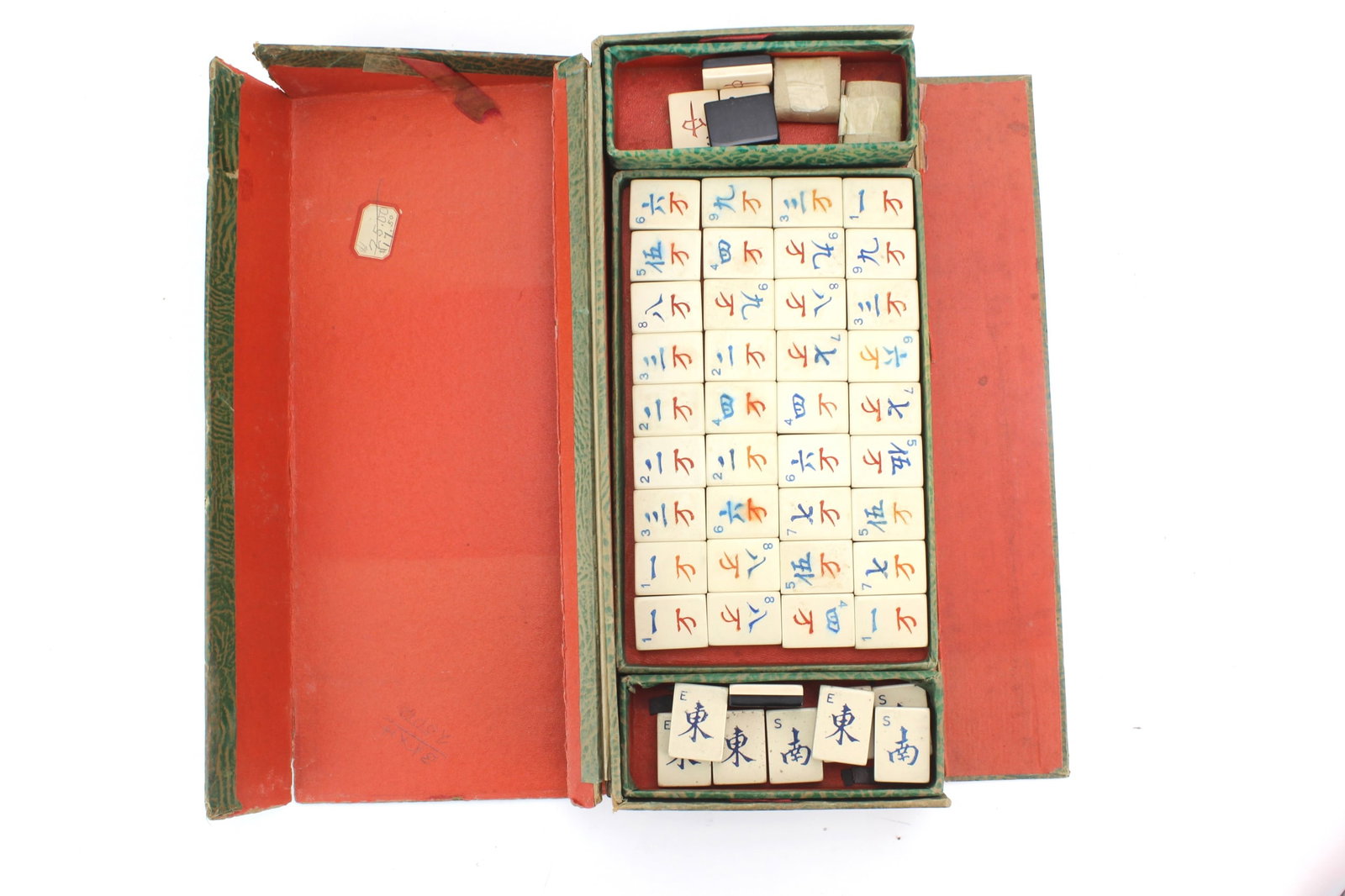 Vintage Mahjong Tile Set in Case: Vintage mahjong tile set housed in original fitted storage case with carved and painted tiles, including character, bamboo, and circle suits. Box measures 12 in. (L) X 2 in. (H) X 5 1/2 in. (W).