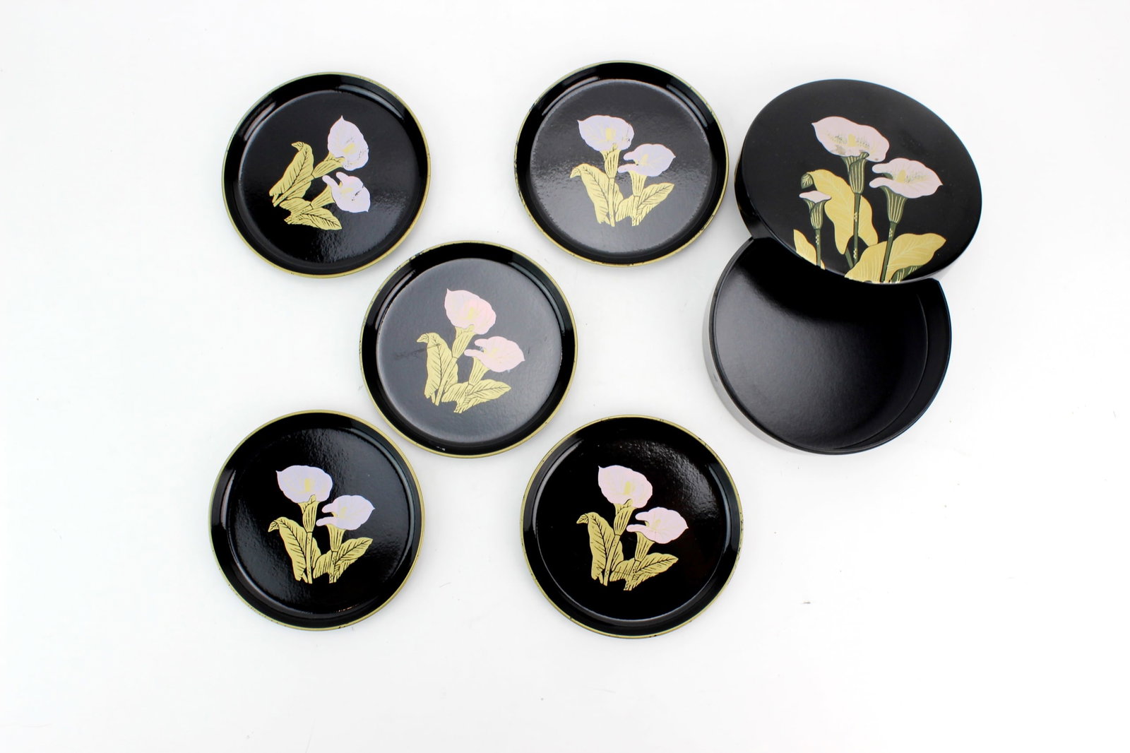 Black Lacquer Calla Lily Dish Set: Black lacquer dish set featuring hand-painted calla lily decoration, including five small dishes and one covered box. Box measures 4 3/4 in. (D) X 2 in. (H). Shows light surface wear, minor