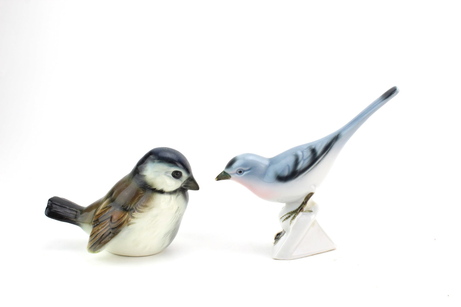 Two Porcelain Bird Figurines: Lot of two collectible porcelain bird figurines including a Goebel bird and another marked Bavaria example. Measures approximately 2 1/2 in. (H) and 4 in. (H). With light surface wear and minor base