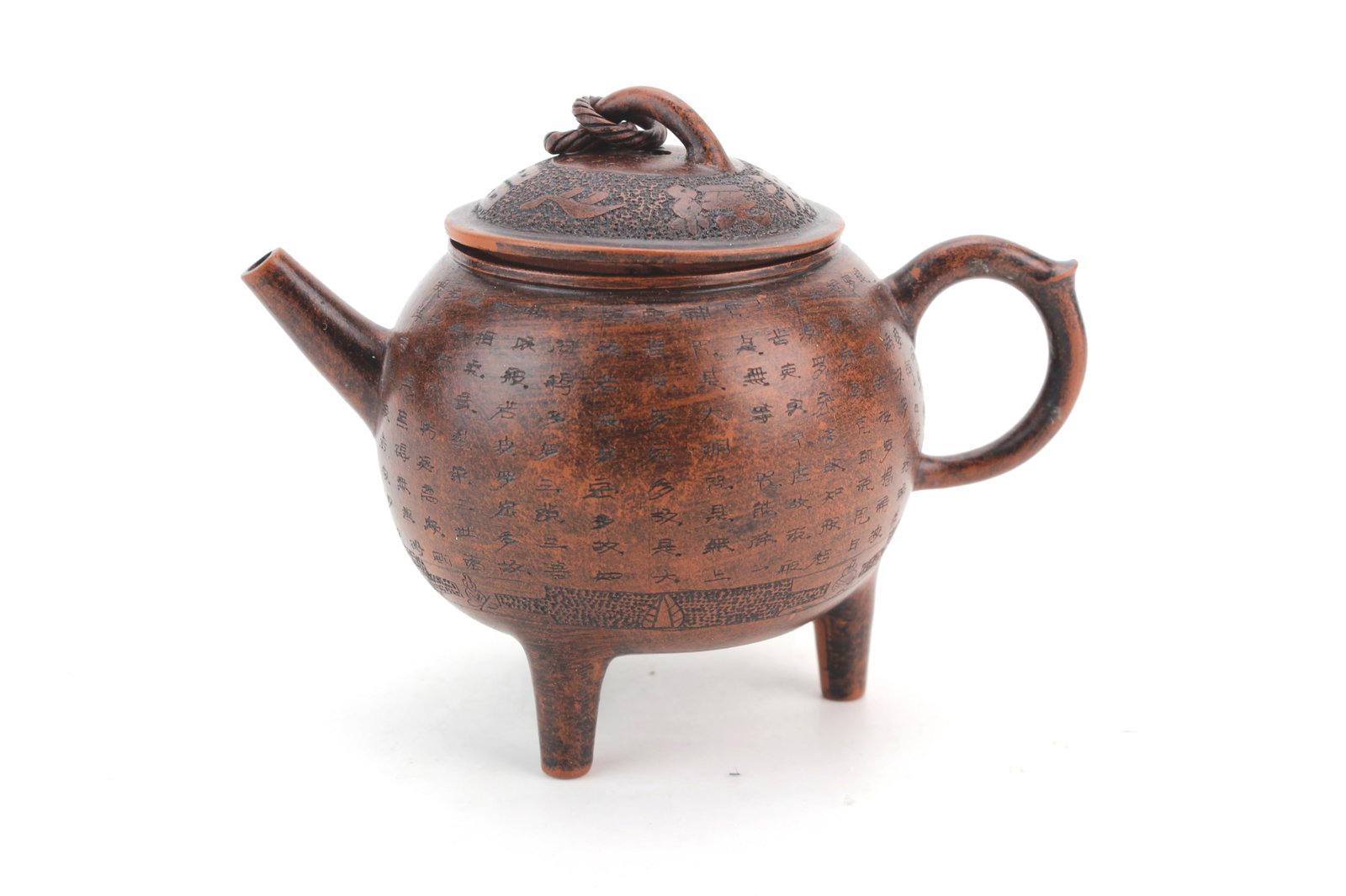 Yixing Zisha Tripod Teapot: Chinese Yixing zisha pottery tripod teapot with incised calligraphy decoration and fitted lid. Measures 3 1/4 in. (H) X 4 1/4 in. (L) X 2 3/4 in. (W). With hairline on body, with light surface wear