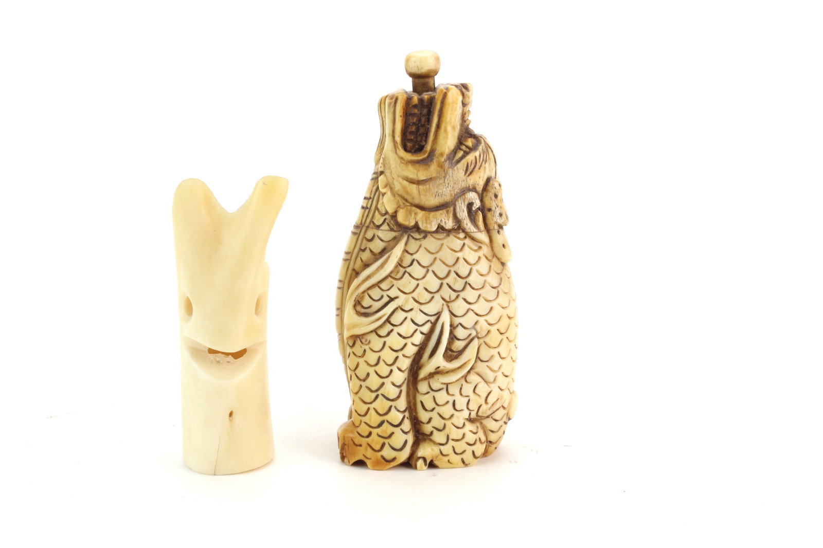 Bone Snuff Bottle & Face Carving: Lot of two carved bone items including a figural snuff bottle with stopper and a small abstract bone carving. Snuff bottle measures 4 in. (H); bone carving measures 3 in. (H). Tiny hairline on the