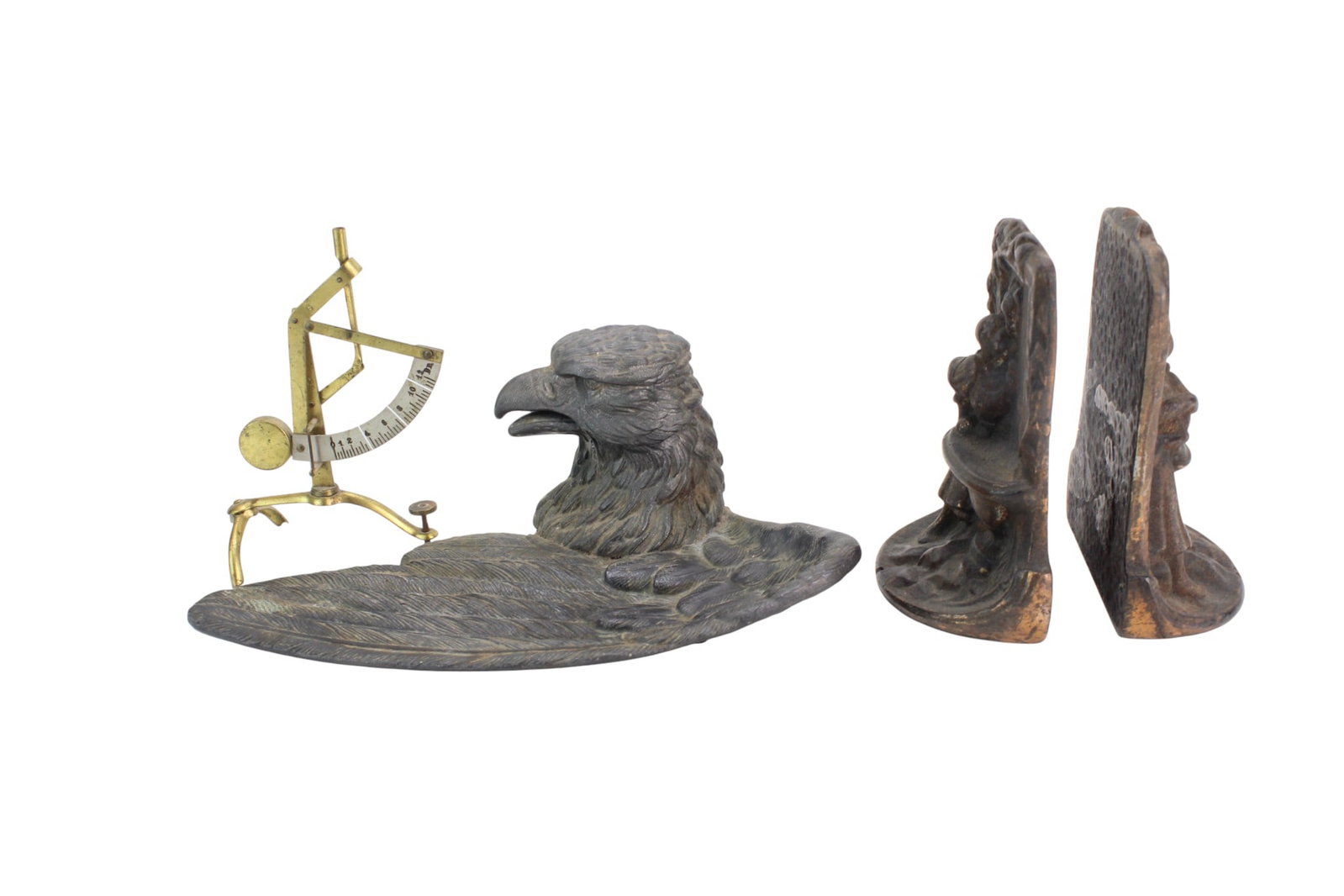 Group of Decorative Metal Table Items: Group of three metal table items including an eagle-form tray, a pair of figurative metal bookends, and a brass angle measurer marked ?Made in Germany.? Sizes: tray 9 X 5 1/2 X 3 1/2 in.; bookends 5