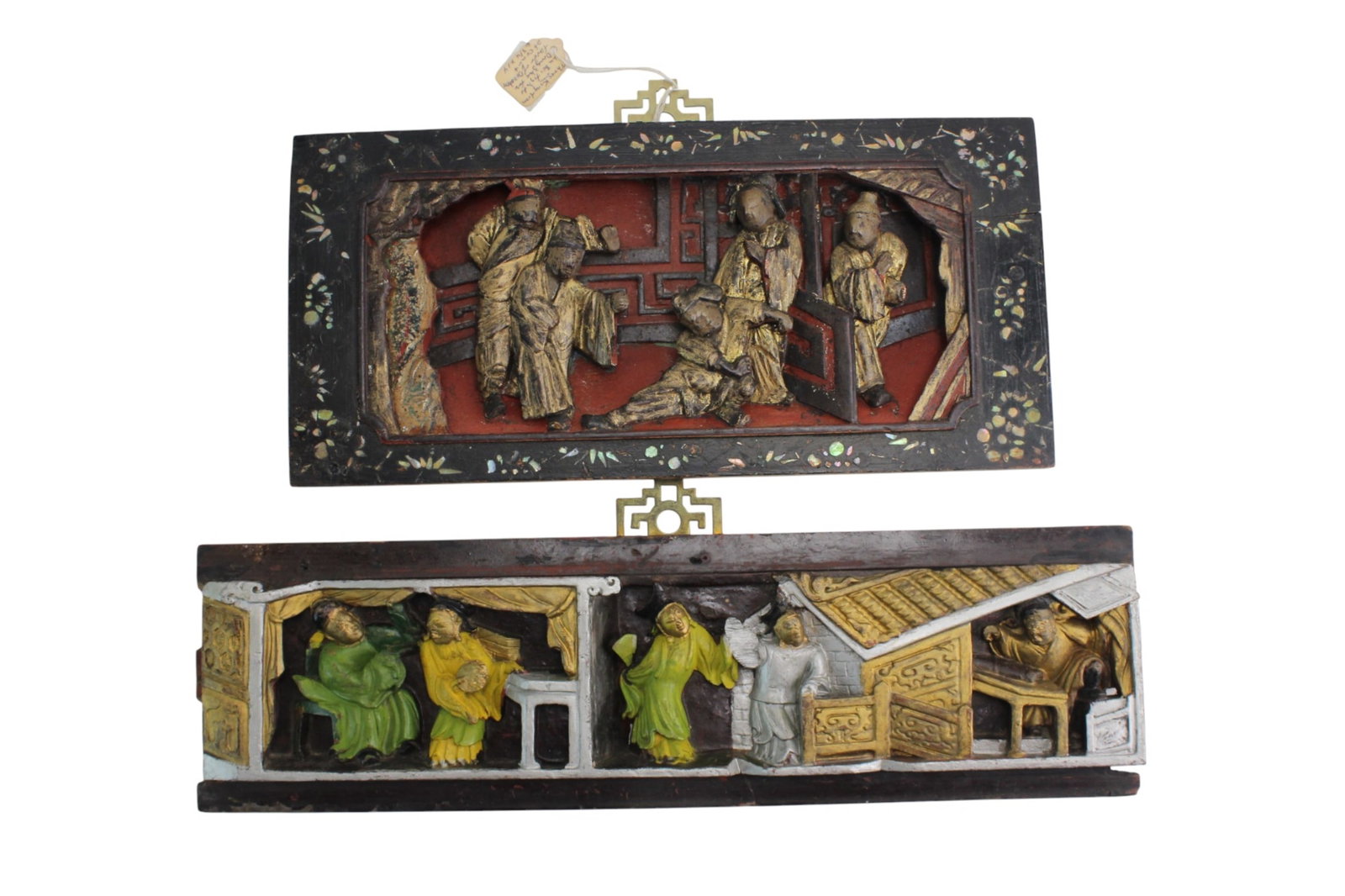 Pair of Chinese Polychrome Wood Carved Panels: Two Chinese polychrome carved wood panels depicting figural narrative scenes with architectural and interior settings. Sizes: 17 3/4 X 5 1/4 X1 in. and 14 X 6 3/4 X1 in., respectively. Condition shows
