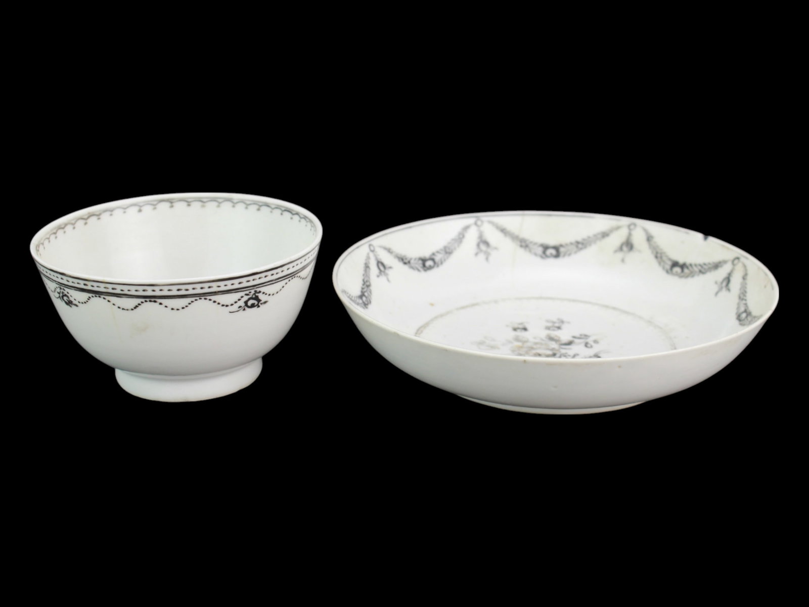 Chinese Export Famille Rose Teacup and Saucer: An 18th-century Chinese export porcelain teacup and saucer set, decorated in fine grisaille (black enamel) with floral motifs and garland swags. Some age-related wear and minor rim chips are present.