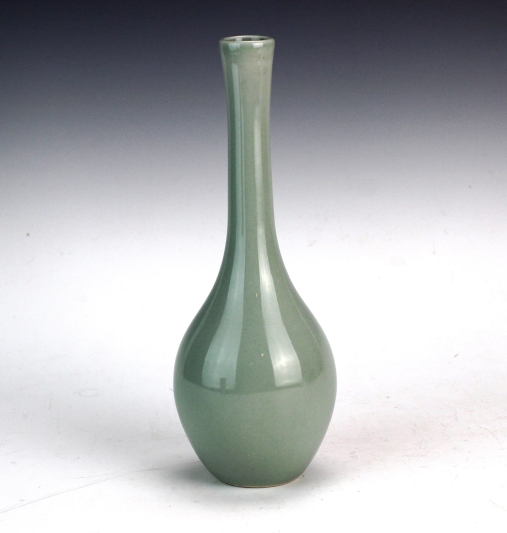 Chinese Porcelain Celadon Yuhuchun Vase: Chinese celadon-glazed Yuhuchunping vase with tapered neck and pear-shaped body. Even soft green glaze with unglazed buff foot. Approx. 9 3/4 in. H x 3 3/4 in. D. Very good condition with minor wear.