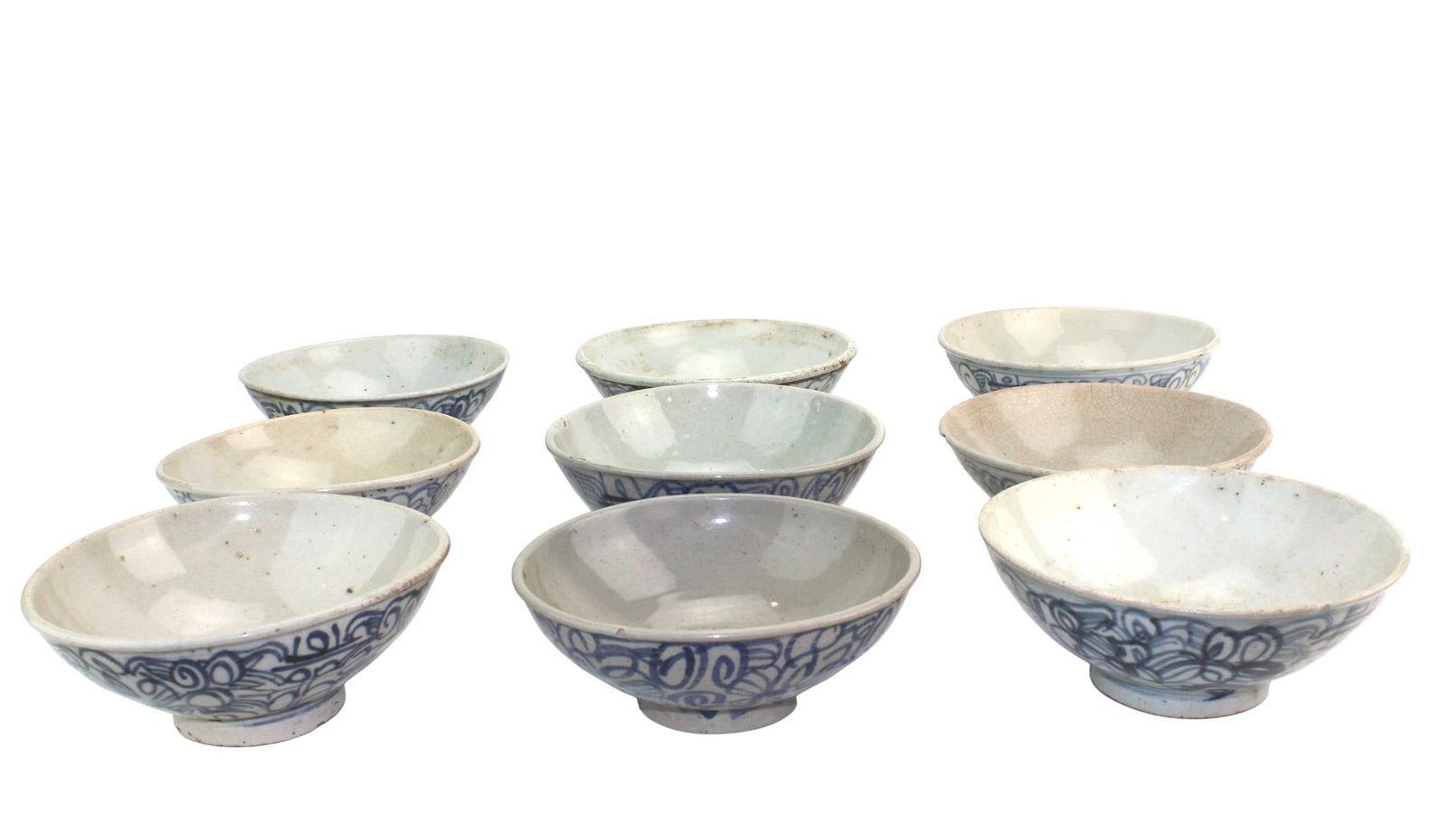 Nine Chinese Blue & White Porcelain Bowls: Nine Chinese blue-and-white bowls (largest 6 1/4 ? 2 1/2 in.) with scrolling designs, showing mixed wear including frits, hairlines, staining, firing flaws, and base losses.