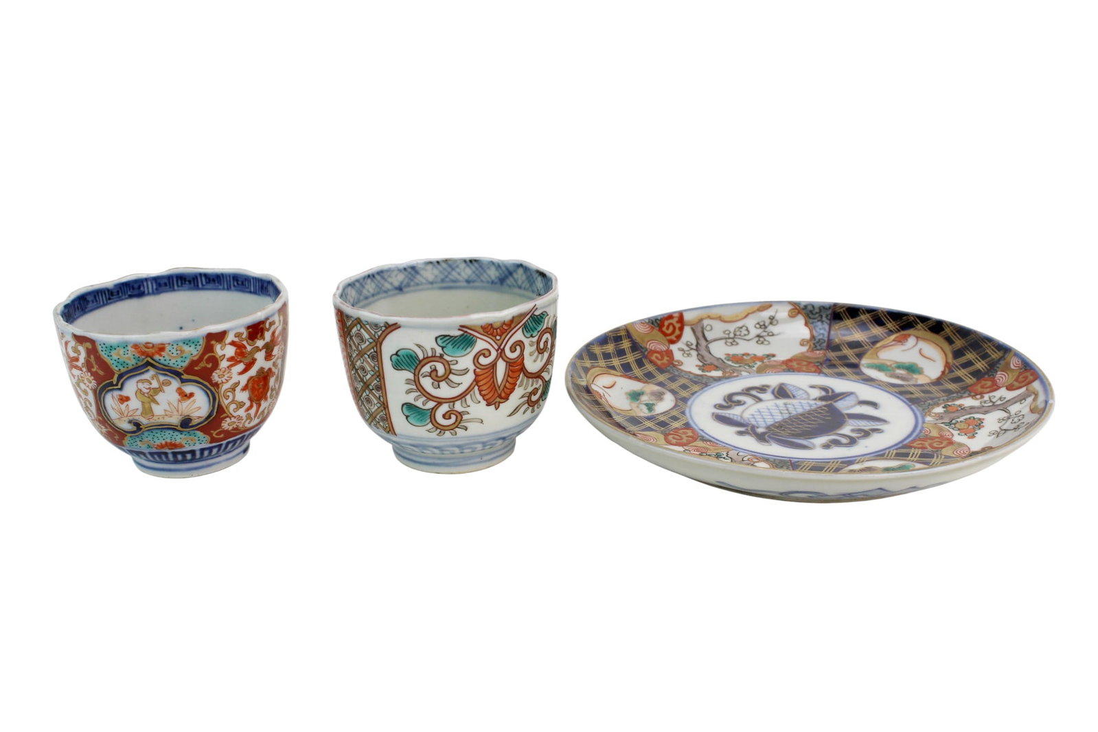 Three Chinese Imari Porcelain Cups & Saucer: Set of three Chinese Imari porcelain pieces, including two cups and one saucer, decorated in underglaze blue, iron red, and gilt with floral and geometric motifs; Sizes:Saucer: 7 1/4 in. (D); Cups: