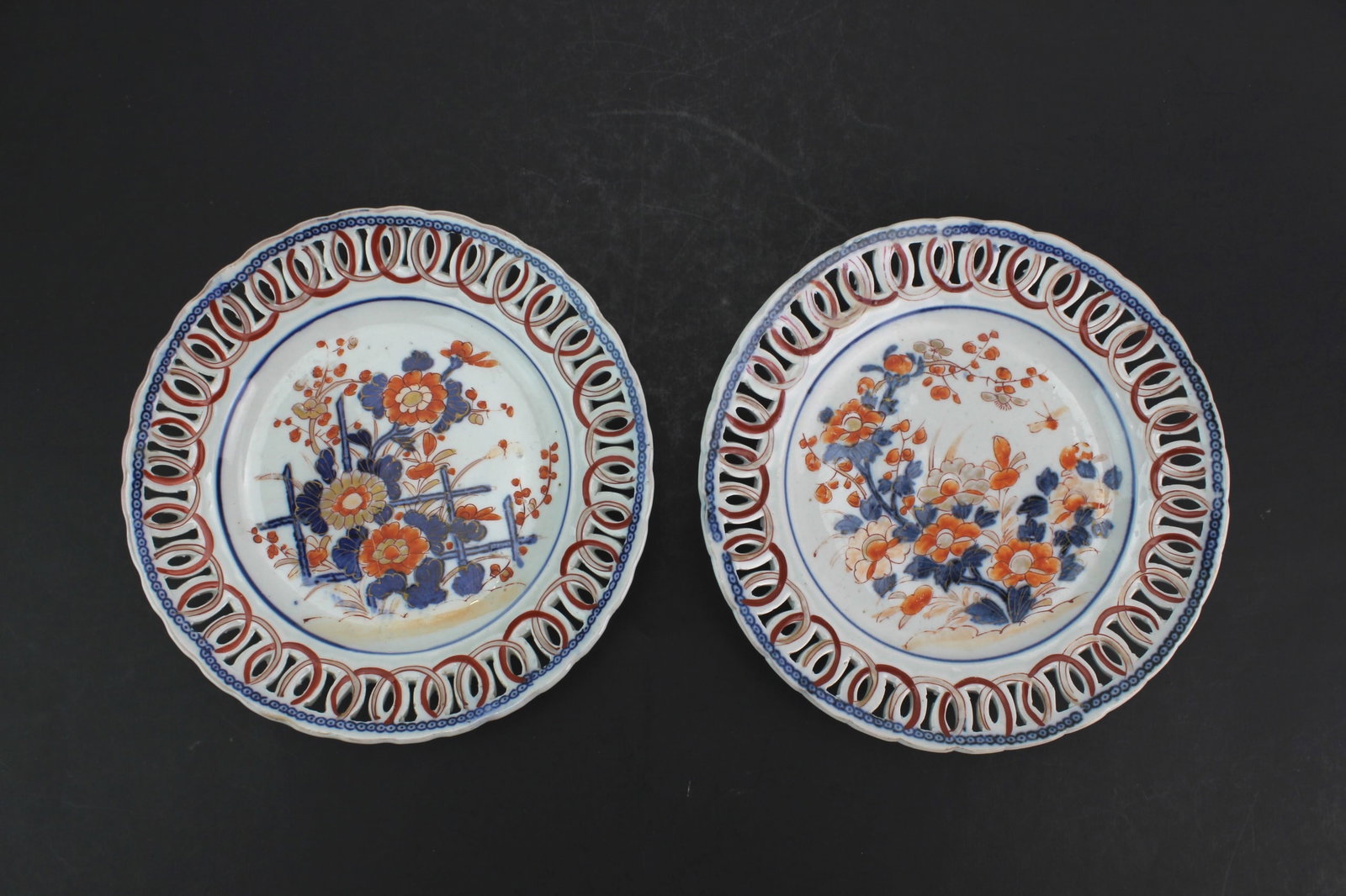 Pair Japanese Imari Reticulated Plates: A pair of late Meiji Japanese Imari reticulated porcelain plates with openwork rims and blue, iron-red, and gilt floral decoration, measuring 1 1/4 in. (H) x 8 3/4 in. (D) each. In overall good antiqu