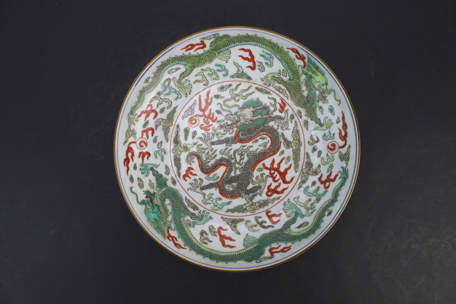 Chinese Famille Verte Dragon Low Bowl: Chinese famille verte porcelain low bowl with dragon decoration and Kangxi-style mark. Measures 8 3/4 in. (D) X 1 3/4 in. (H). Shows light wear and minor glaze imperfections consistent with age; no vi