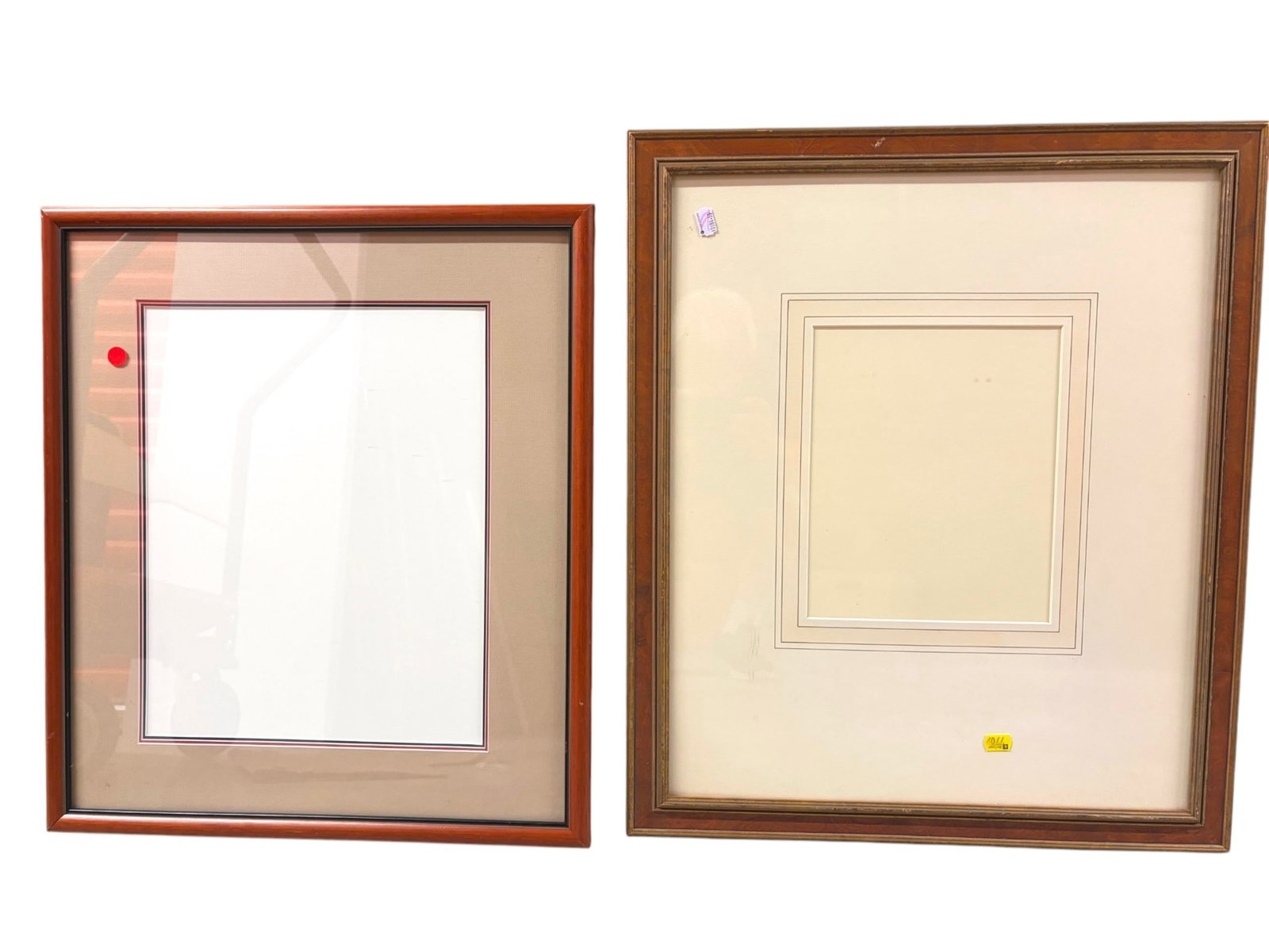 Pair of Wood Picture Frames: Lot of two wood picture frames with mats and glass. Sizes are approximately 23 in. (W) ? 27 in. (H) and 21 1/2 in. (W) ? 24 1/2 in. (H), respectively. Condition: overall good used condition with light