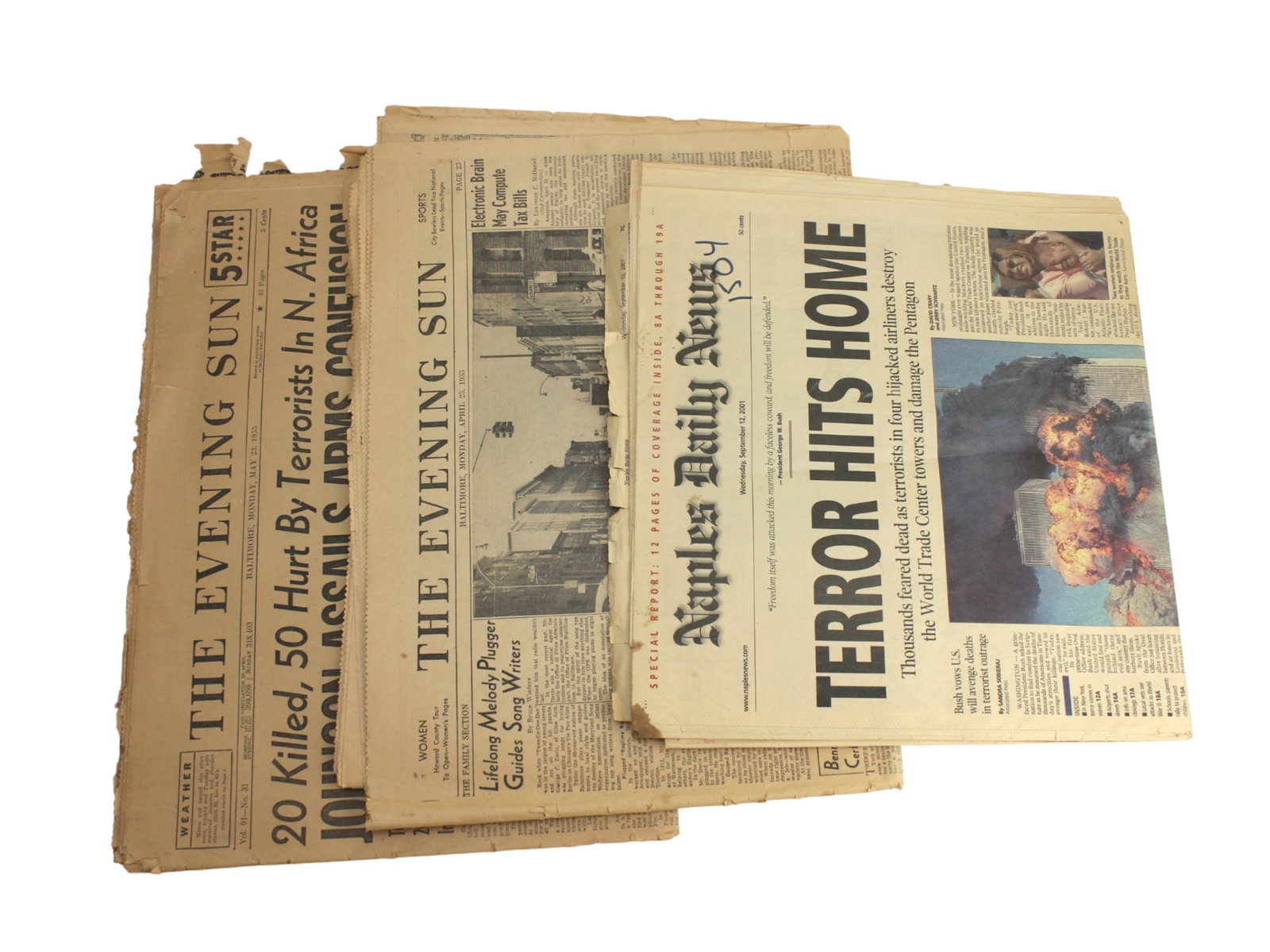 Collection of Three Historic Newspapers: A collection of historic newspapers, including a 2001 Naples Daily News issue on 9/11 and several 1950s editions of The Evening Sun covering major events like terrorism, Cold War tensions, and early