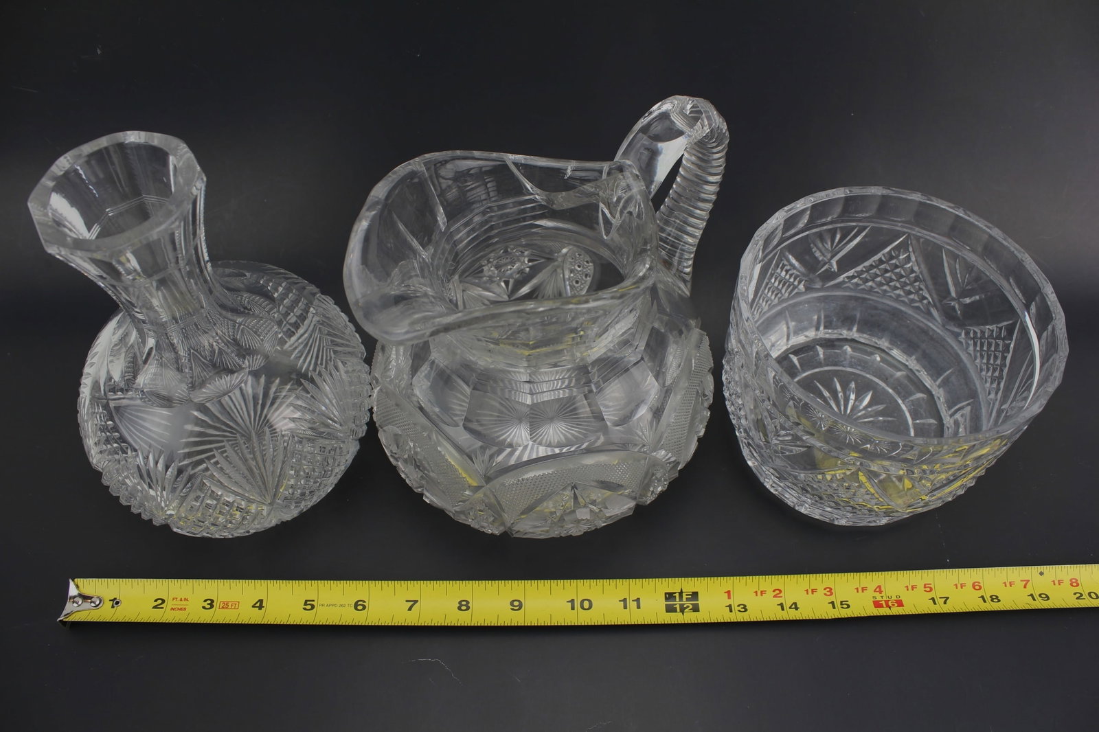 Set Of 3 American Cut Glass Tablewares: Set of three American Brilliant Period cut glass items including a decanter, bowl, and pitcher, each with intricate geometric and starburst patterns. The pitcher has a chipped spout. Sizes range from