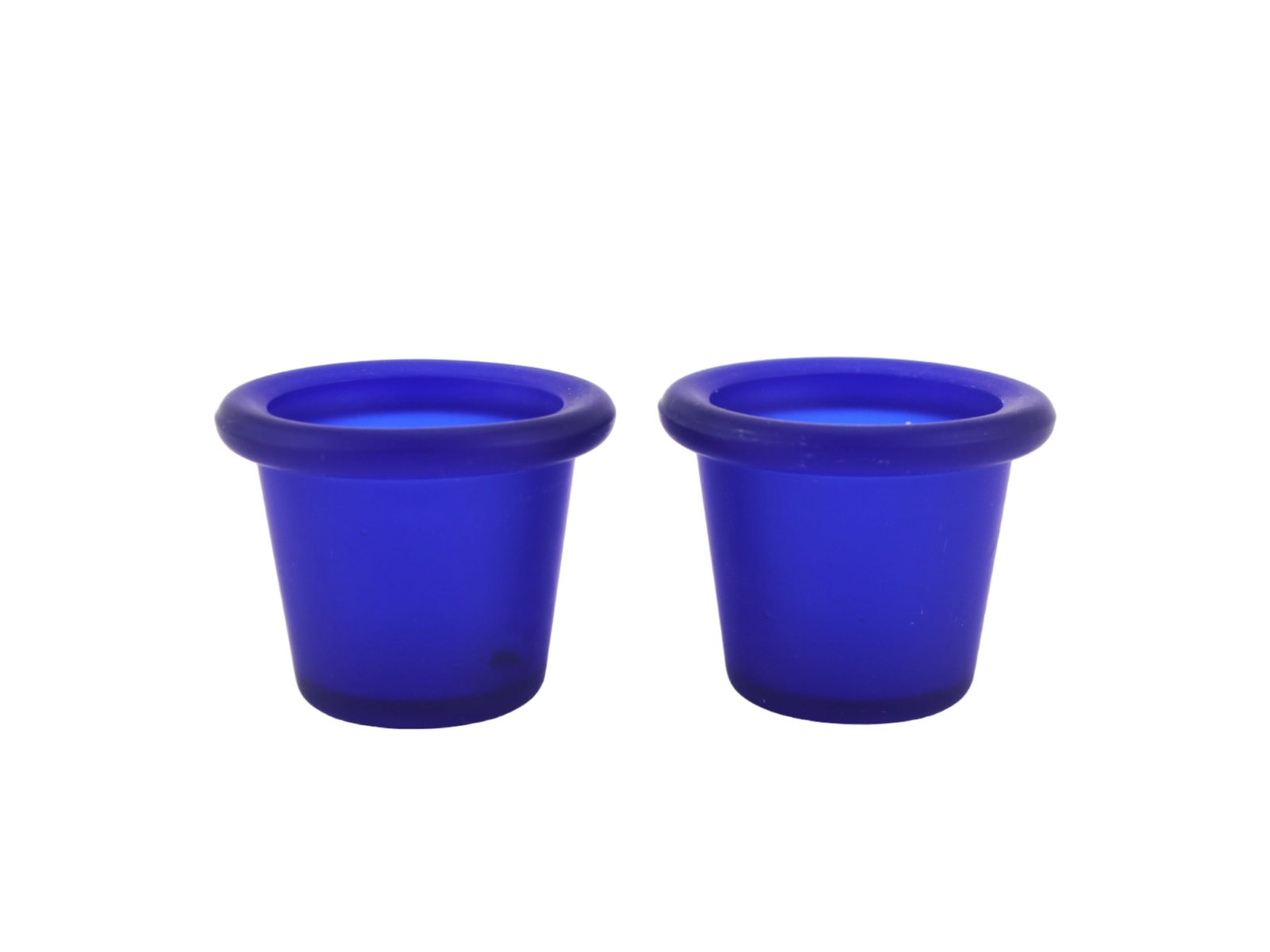 Pair of Cobalt Blue Frosted Glass Votive Holders: This matching pair of small frosted glass votive holders features a rich cobalt blue hue and a smooth matte finish. Designed by RATIA for Design Ideas (Springfield, IL), each piece is approximately
