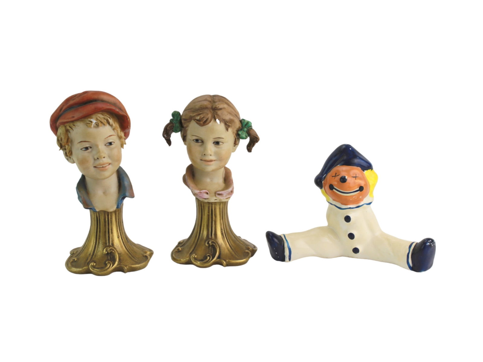 Trio of Vintage Porcelain Figurines: This is a set of three vintage porcelain figurines: a boy and girl bust signed "Benacchio" on ornate gold-tone bases, both in 4 3/4 in. tall, and a colorful clown in a sailor outfit marked "Japan." in