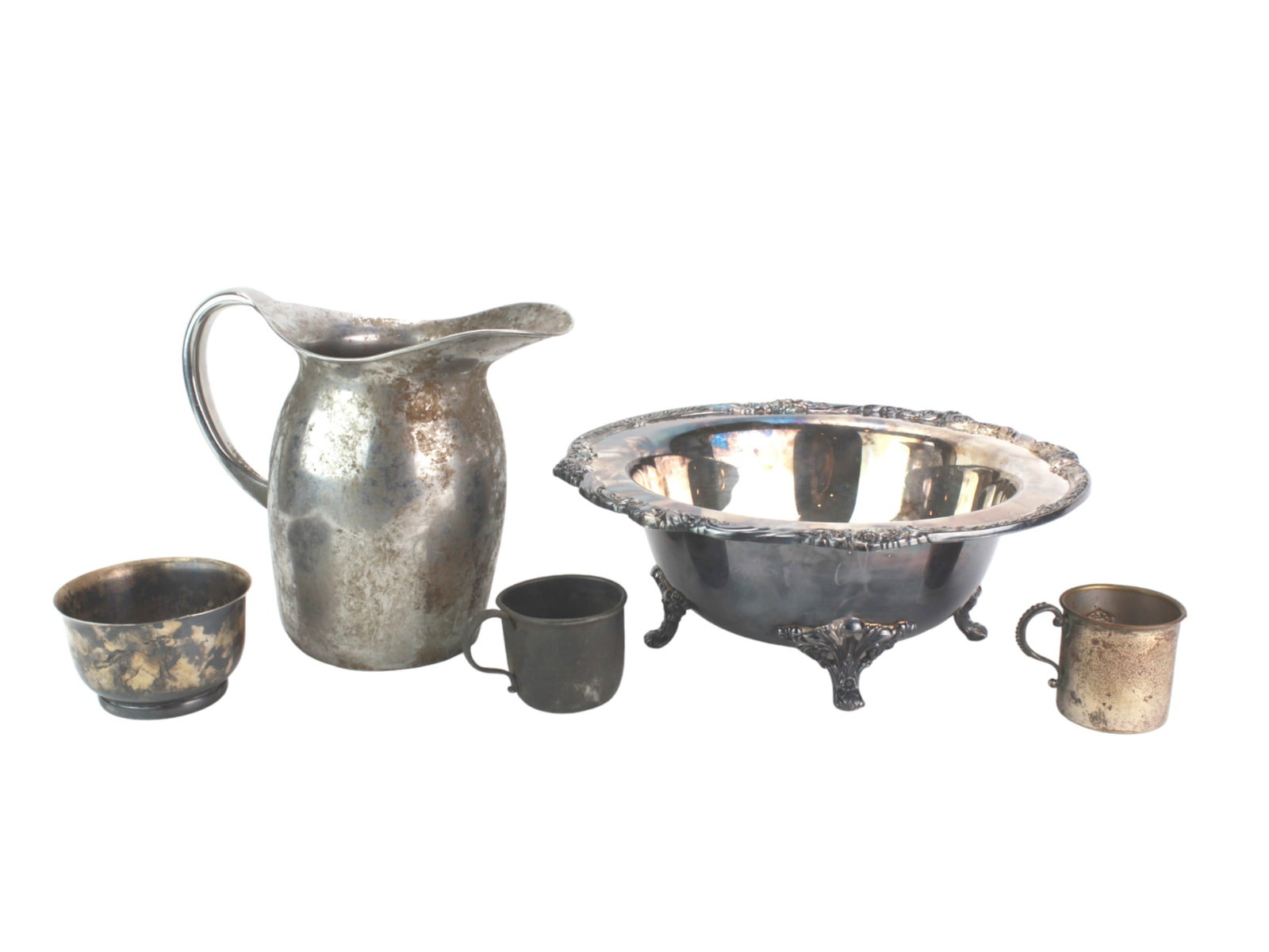 Vintage Silver Plate Tableware Collection: A group of five vintage silver-plated items including an ornate punch bowl in 12 in. Diam.; a tall water pitcher in 7 1/2 in. Tall, and three assorted cups. The pieces show patina from age and