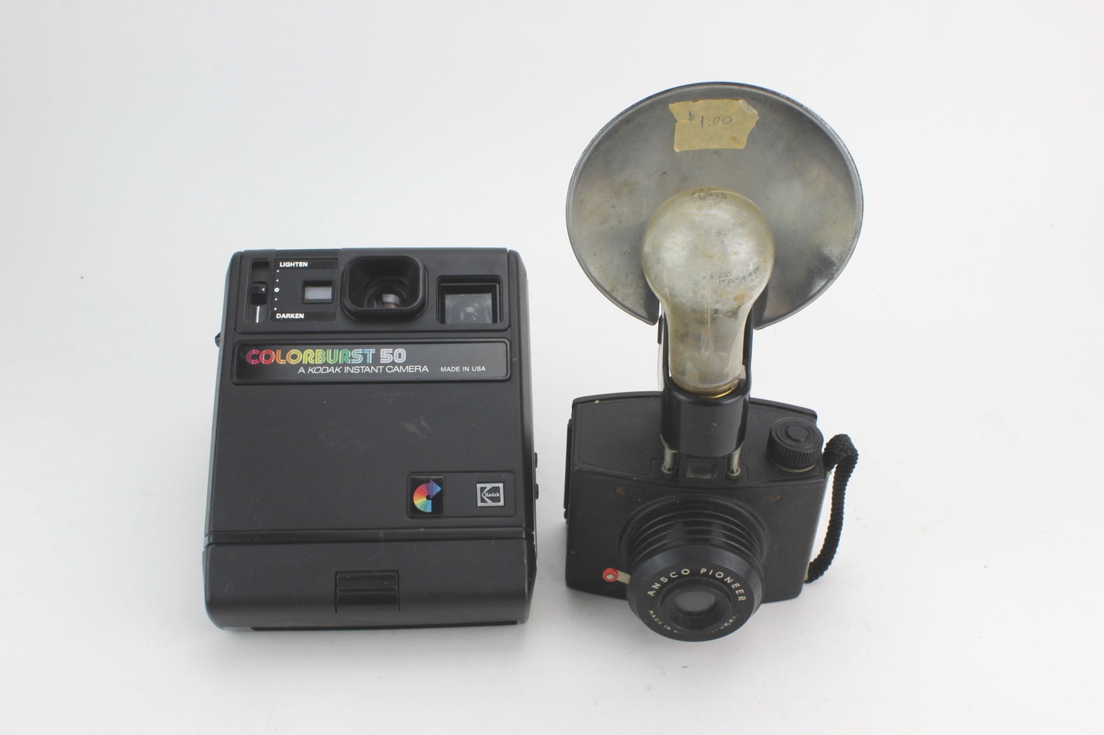 Kodak & Ansco Vintage Cameras: Group includes a Kodak Colorburst 50 instant camera and an Ansco Pioneer camera with built-in flash reflector. Condition: Both cameras show light to moderate cosmetic wear from age and use, including 