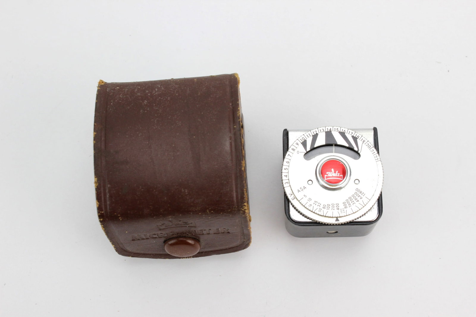 Vintage Walz Micro-Meter Light Meter: Vintage Japanese Walz Micro-Meter photographic light meter with original leather case. Good vintage condition with surface wear and scratches; case shows wear and cracking. Untested.