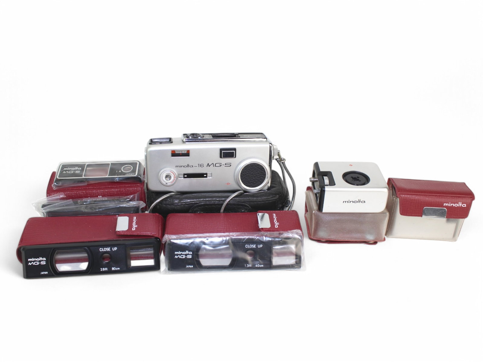 Minolta-16 MG-S & Accessories: Minolta-16 MG-S 16 mm miniature camera. Circa 1969-1974. With two MG-S Cube-Gun Flashes, multiple filters, and two close-up with 1.3 ft, 40cm & 2.6 ft, 80cm.