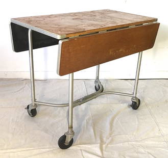 Warren MacArthur Rolling Drop Leaf Table: Aluminum and wood rolling cart or table with drop leaves and locking casters. Opens to a size of 36" by 36". Closed it is 21 3/4" by 36" and 30" high.