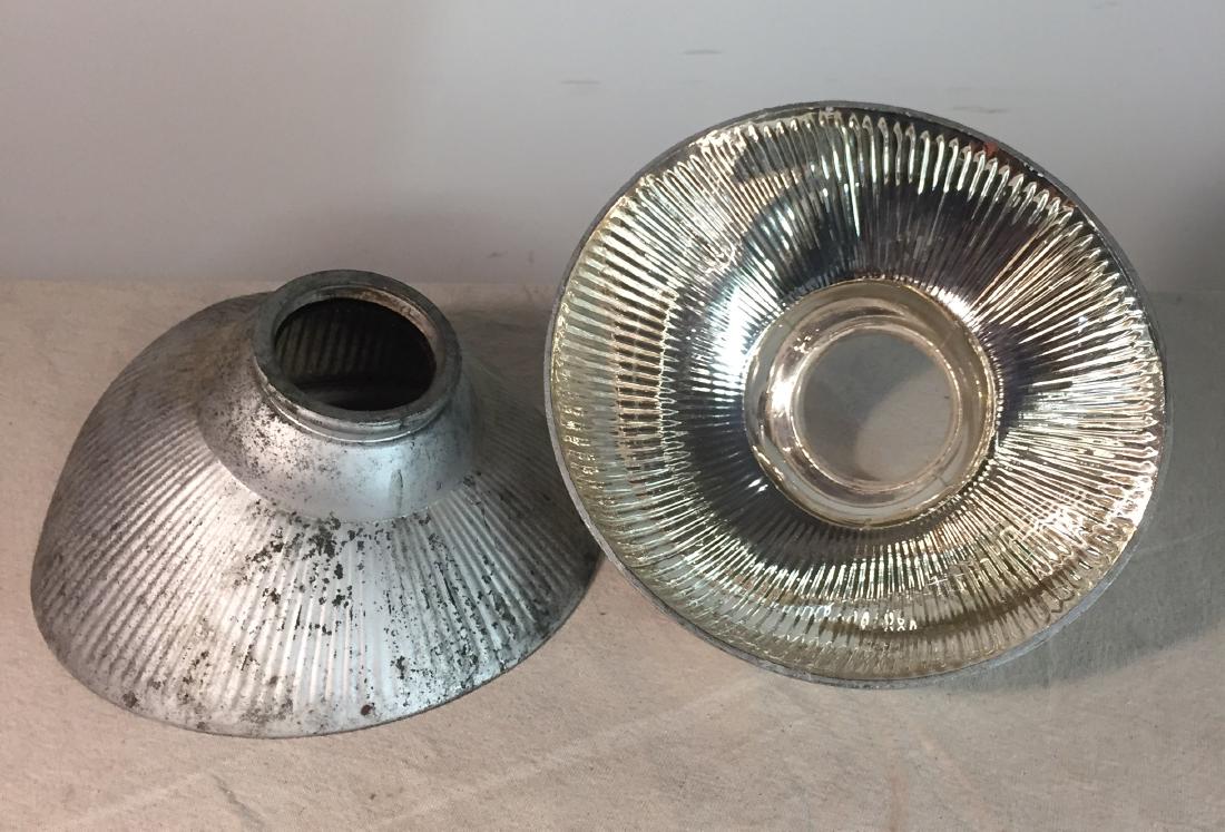 Pair Pittsburgh Permaflector Shades: Two mercury glass shades marked Pittsburgh Permaflector. Some edge chips and discoloration to one. 9 1/2" at large end, 3 1/4" at small end.
