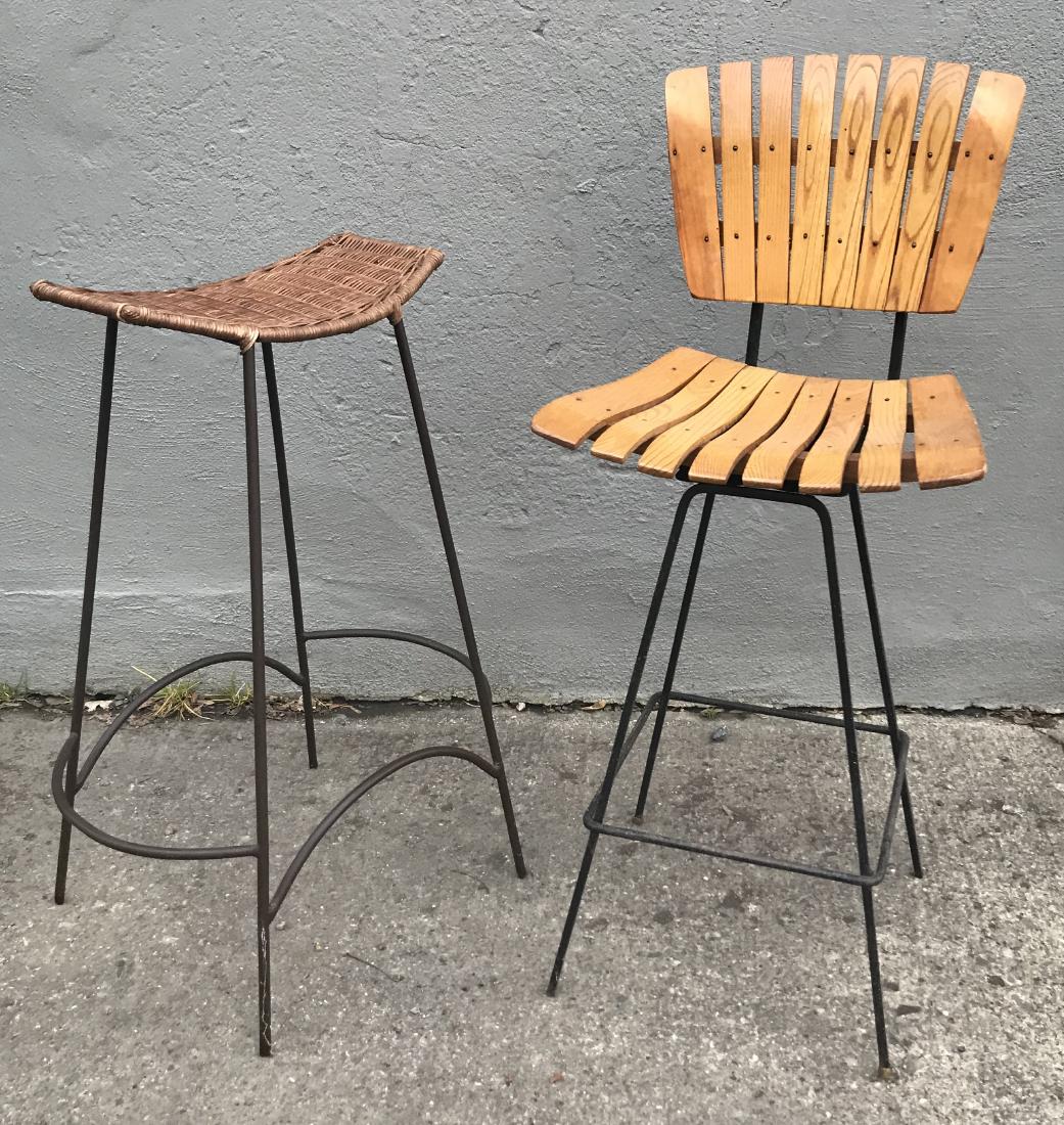 Mid-Century Bar Stools Iron and Wood: 1.) Backless wicker seat round iron stool. 22"W x 16"D x 30"H. 2.) Slatted oak seat and back, swivel square iron. 17"W x 16"D x 38.5"H. Seat 26"H
