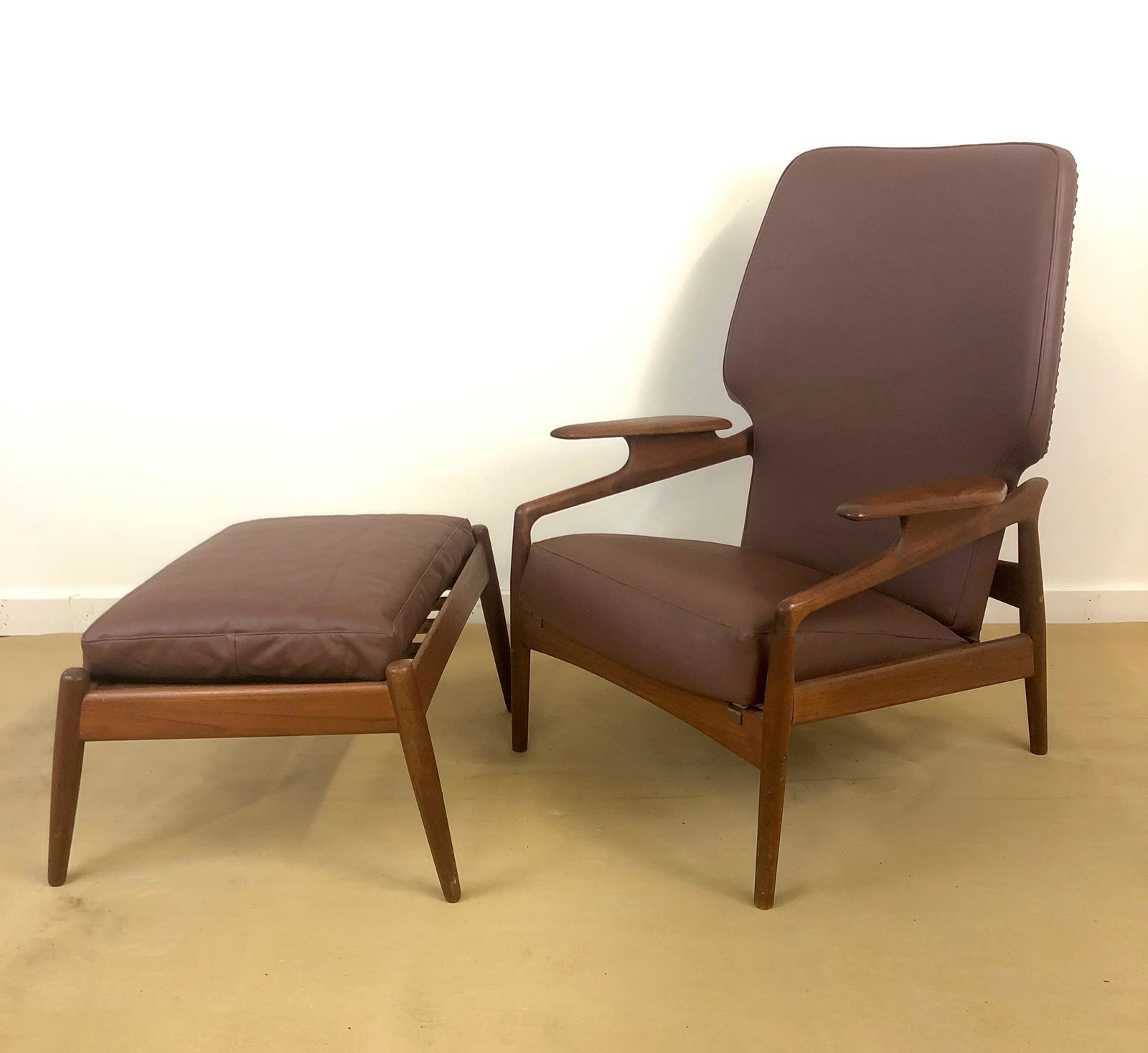 Danish Teak Reclining Chair and Foot Stool by John Bone: Mid Century teak reclining chair and foot stool. Newer leather upholstery, nailhead detail. 28 x 25.5 x 39h stool 24 x 18 x 15h