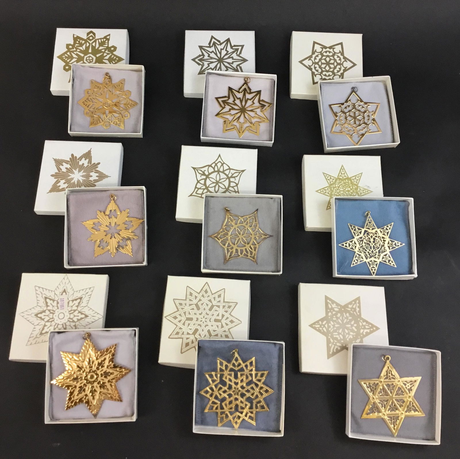 Lot of 9 MMA Metropolitan Museum Stars Christmas: Lot of 9 MMA sterling silver with gold wash Star Christmas ornaments from the 1980's. From the years 1980 through 1988. Each has the original box, pouch, and papers. Boxes measure 4" x 4" x .75"