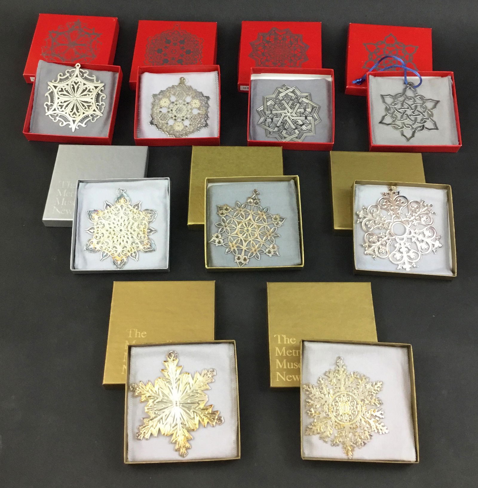 Lot of 9 MMA Metropolitan Museum Sterling Silver: Lot of 9 MMA sterling silver snowflake Christmas ornaments from the 1990's. There is one from 1990 - 1993, & 1995 - 1999. Each has original box, pouch, and paper. Boxes 4" x 4" x .75"
