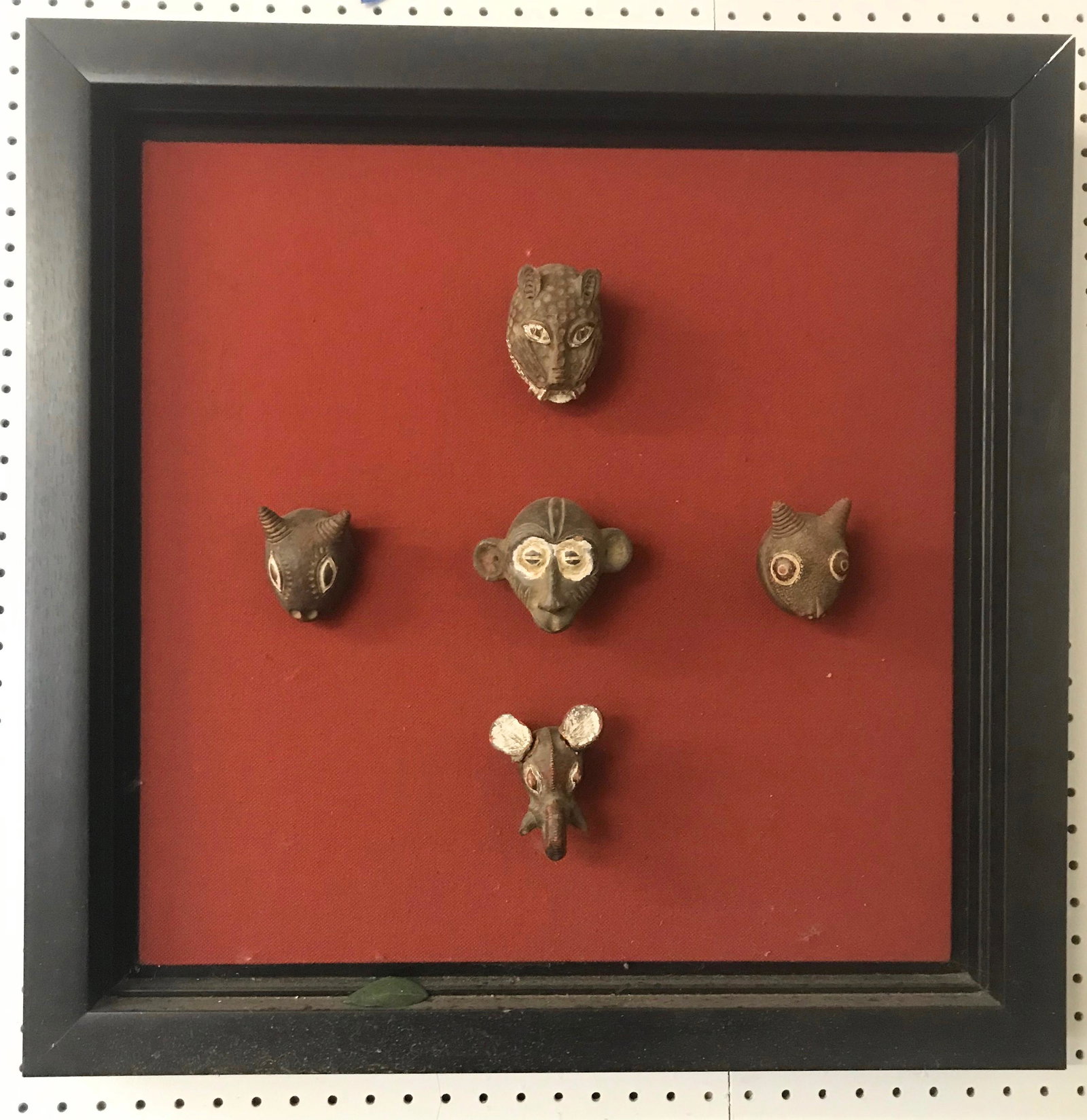 Framed African Passport Dan Tribe Masks: Frame with a total of 5 masks. Pottery figural pieces mounted on burlap.