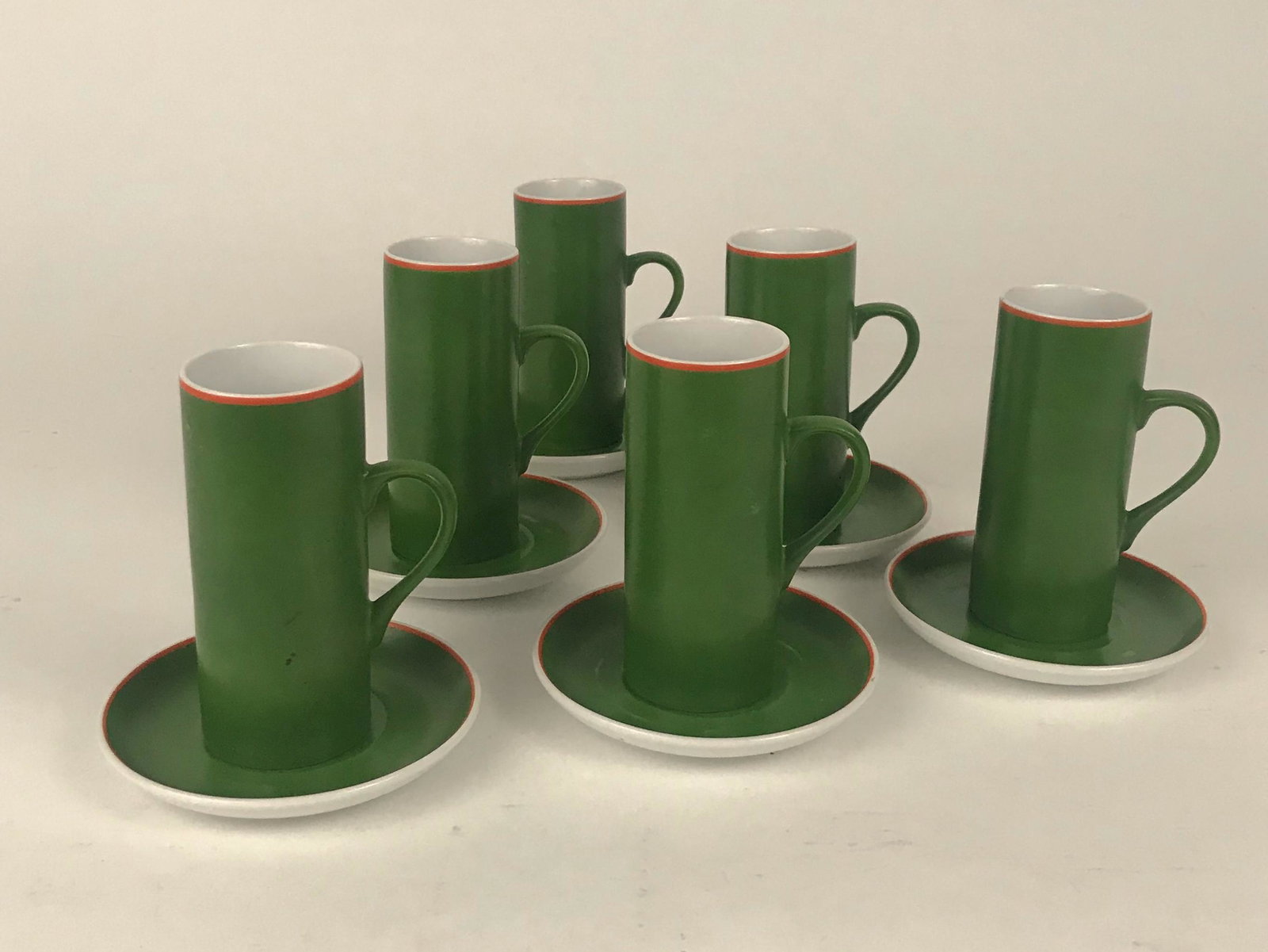 12 Pc. Cups & Saucers set by Lagardo Tackett: 12 piece set of porcelain cups and saucers in a green glaze. Saucers 4"D, Cups 4.125" x 1.75