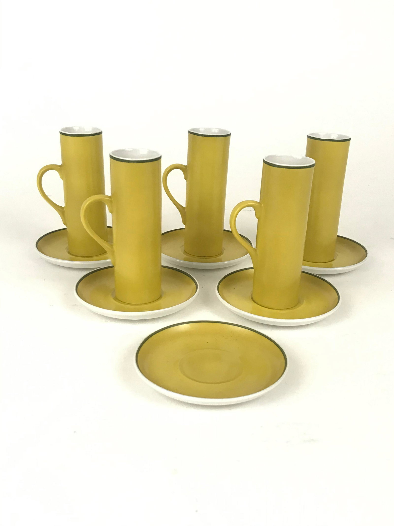 11 Pc. Yellow Demitasse Set by Lagardo Tackett: 11 piece set of porcelain cups and saucers in a yellow glaze. Saucers 3.375"D, Cups 3.875" x 1.25"